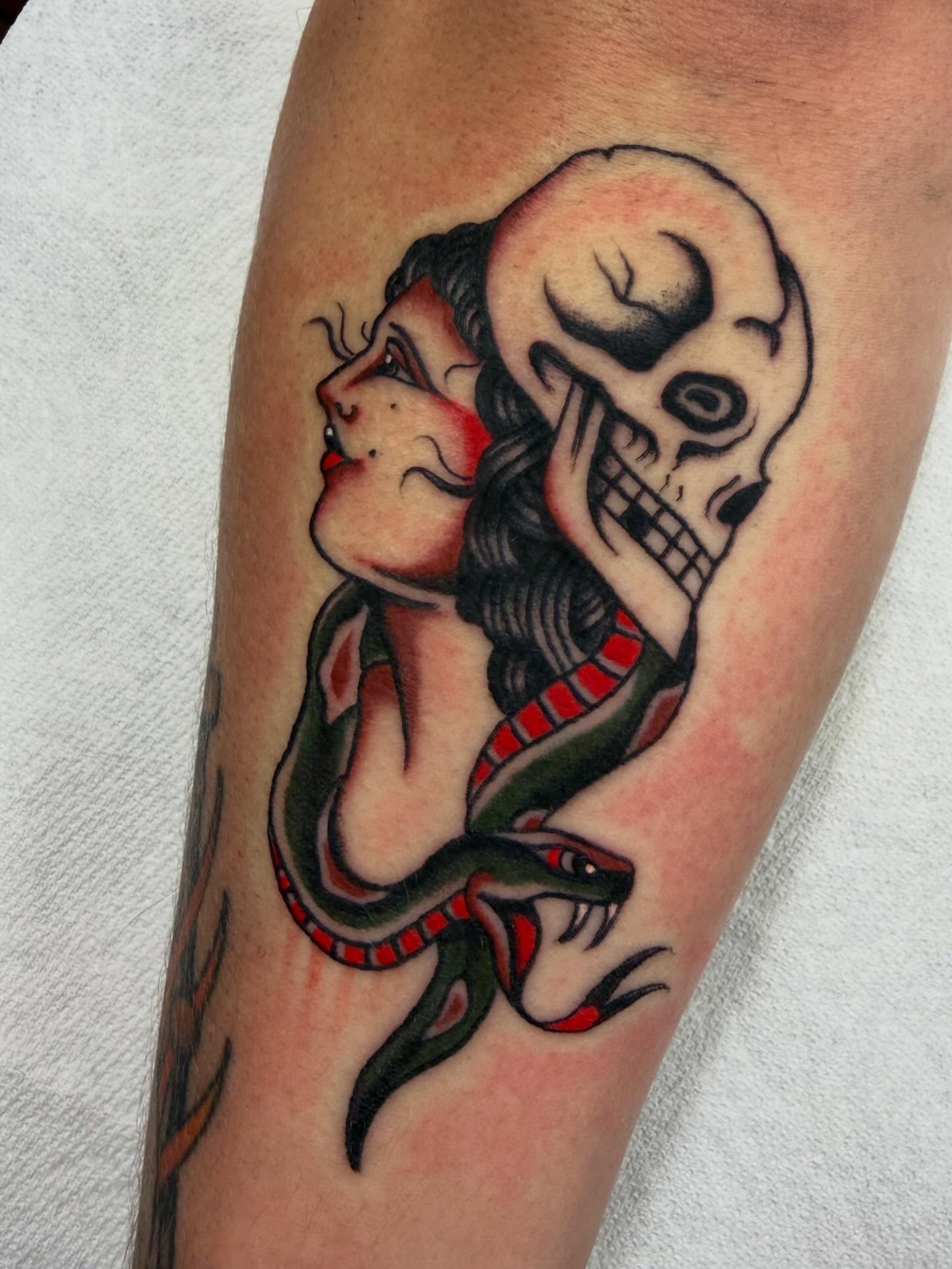 Woman and snake American traditional tattoo on the forearm by David Evans