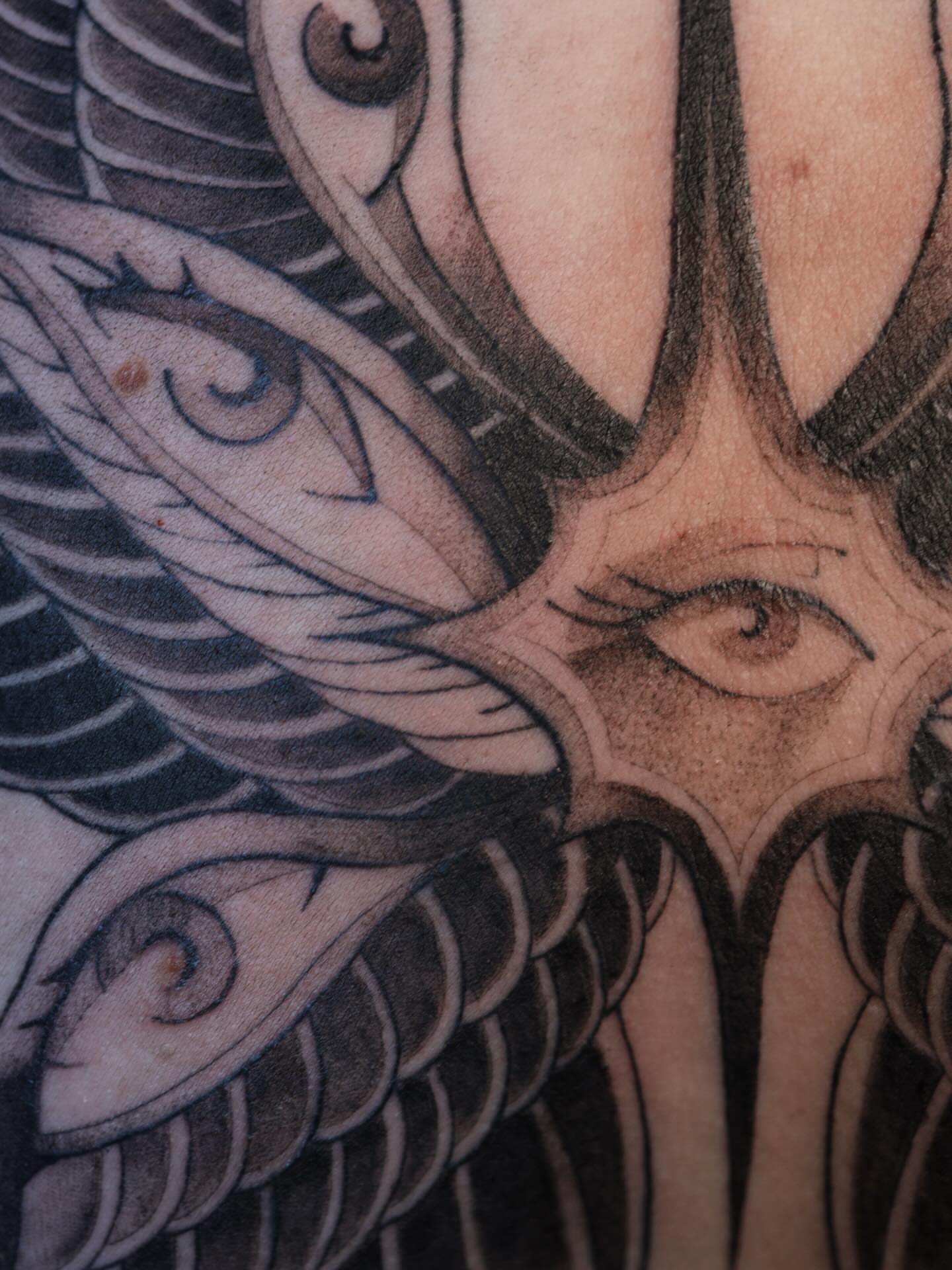 Eyes and feathers geometric tattoo by morgan purcey