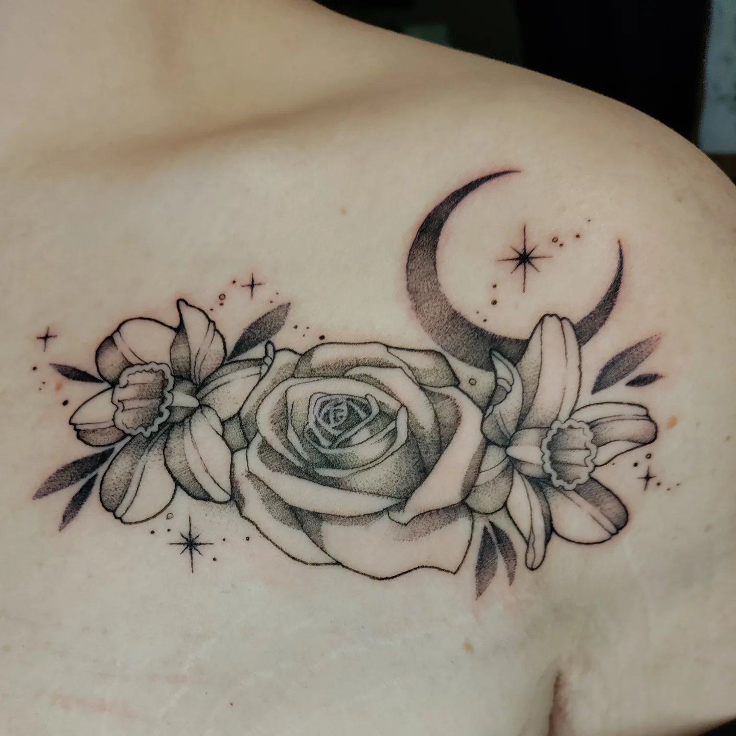 Rose and daffodils black and grey tattoo on the shoulder by Kennedy Jones, Lee's Summit, Missouri
