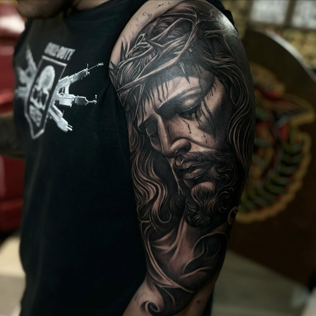Jesus Christ portrait Chicano tattoo on the upper arm by ๐๐๐๐๐๐๐ ๐ฌ.๐ผ