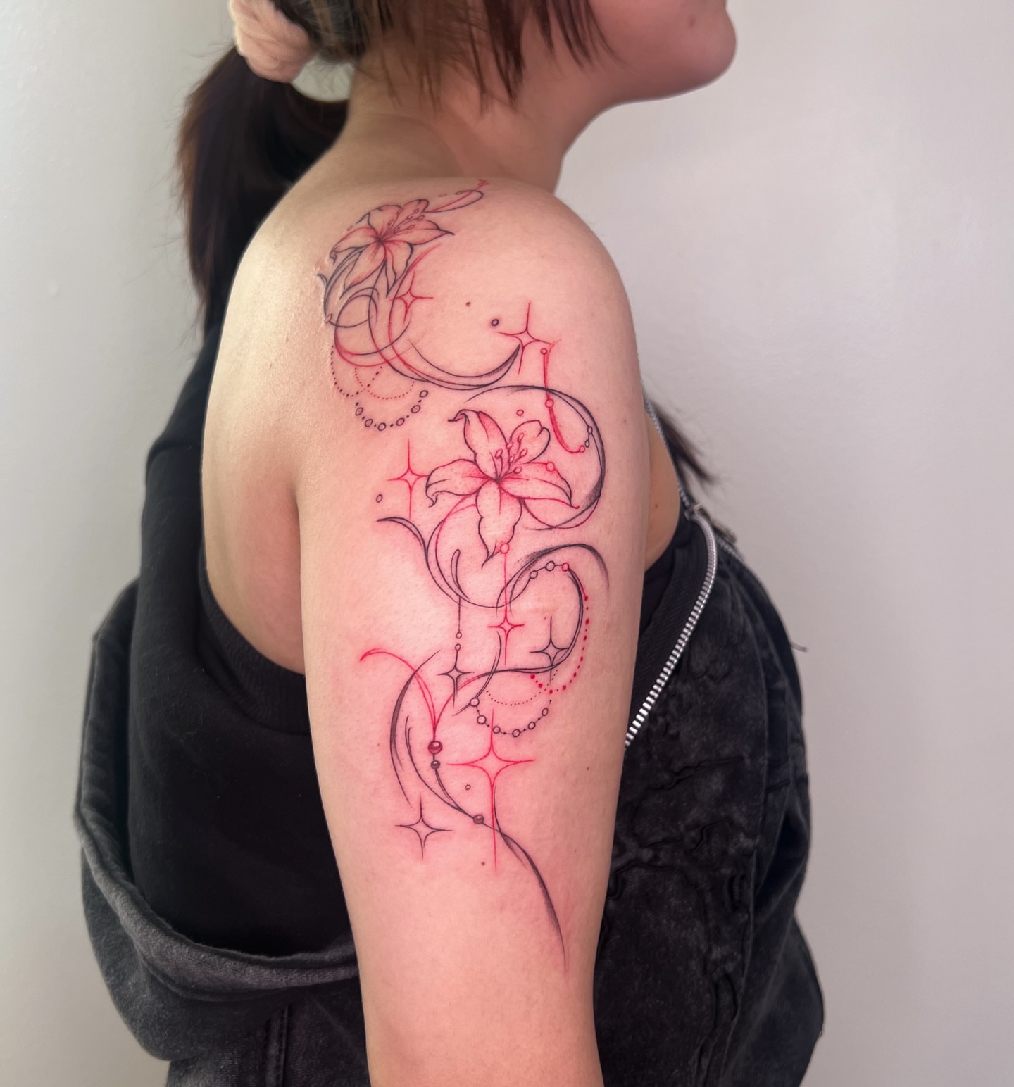 Lily and swirls fine line tattoo on the shoulder by Nhiidles