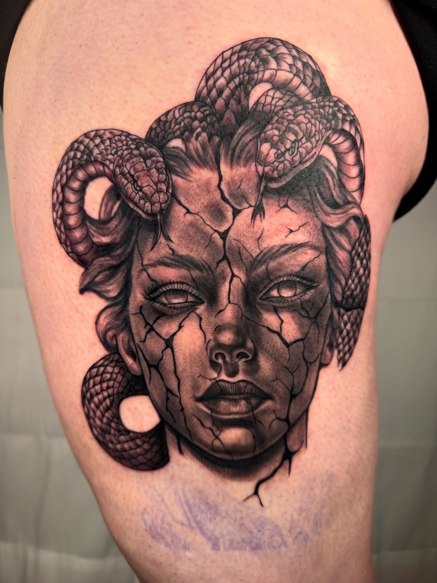 Medusa realism tattoo on the thigh by Tevin Thomas