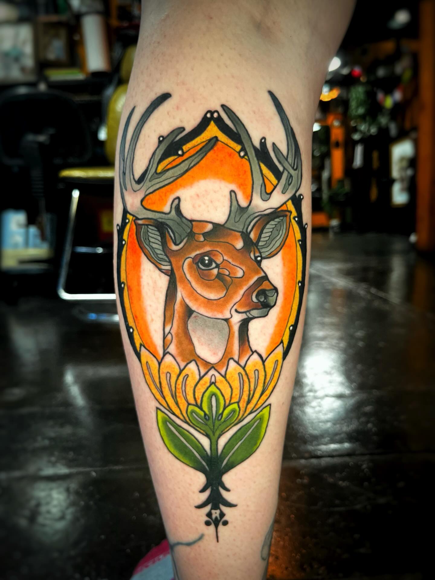 Deer and flower American traditional tattoo on the forearm by Gilbert Gonzalez
