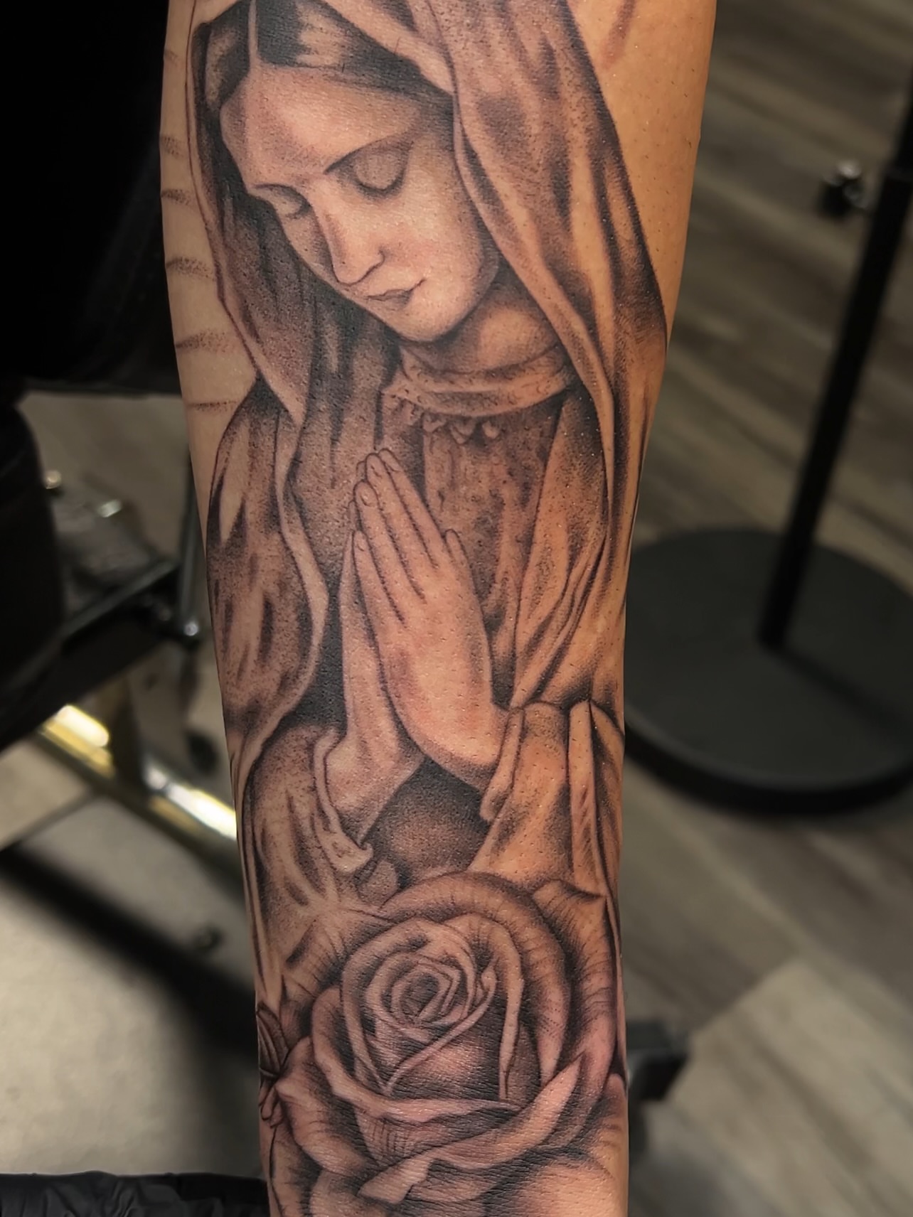 Praying woman with rose realism tattoo on the forearm by Jericho Las Vegas tattoo artist, Las Vegas, Nevada