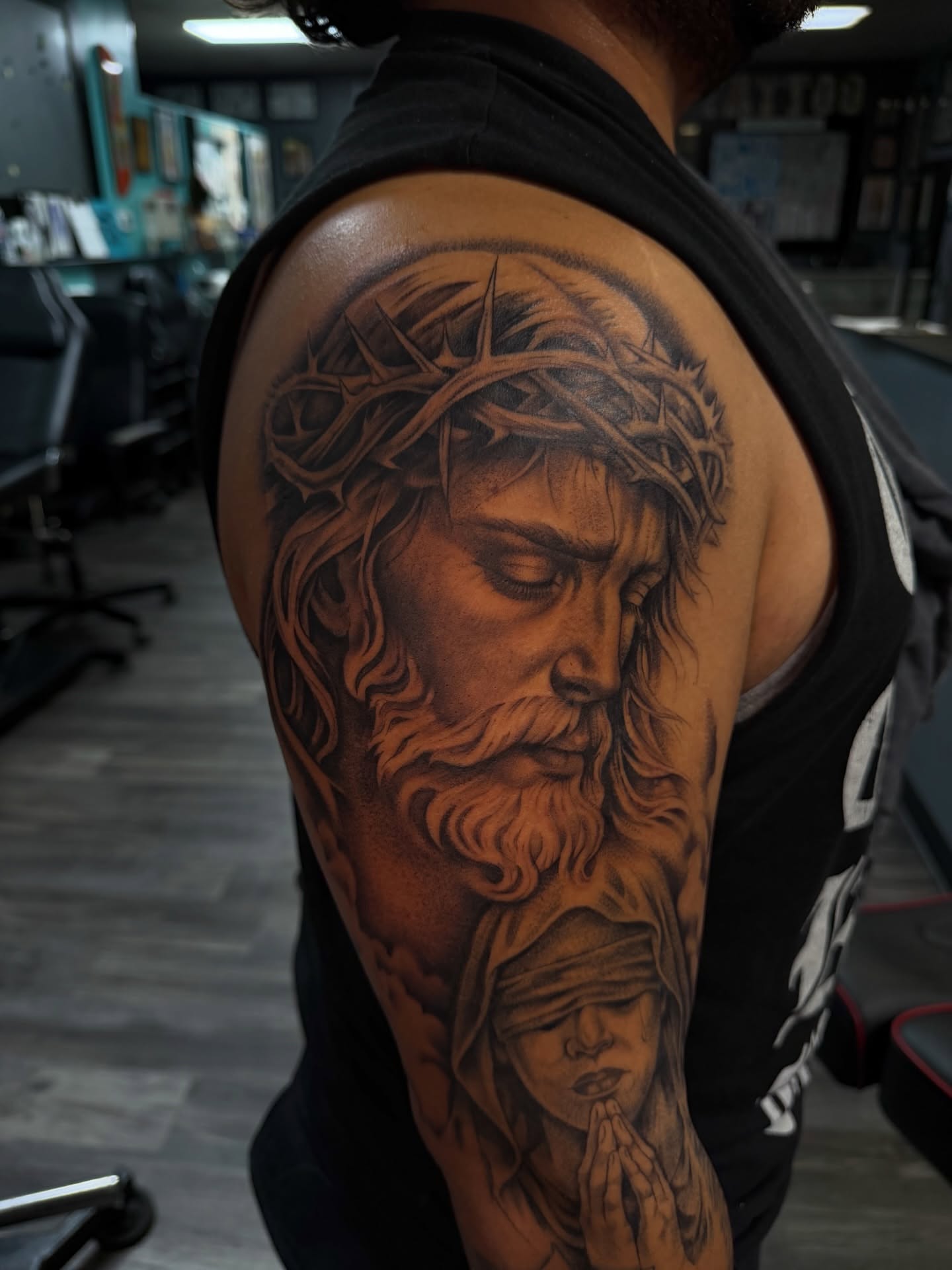 Religious figure and praying child realism tattoo on the shoulder by Jericho Las Vegas tattoo artist, Las Vegas, Nevada