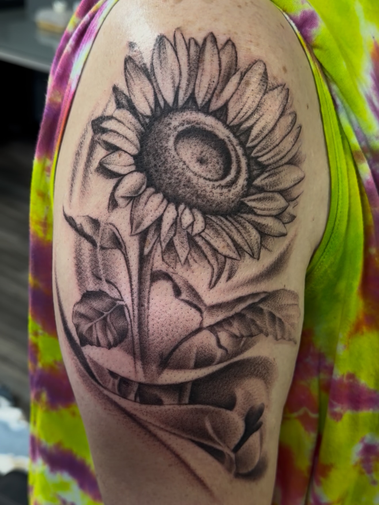 Sunflower realism tattoo on the upper arm by Jericho Las Vegas tattoo artist, Las Vegas, Nevada