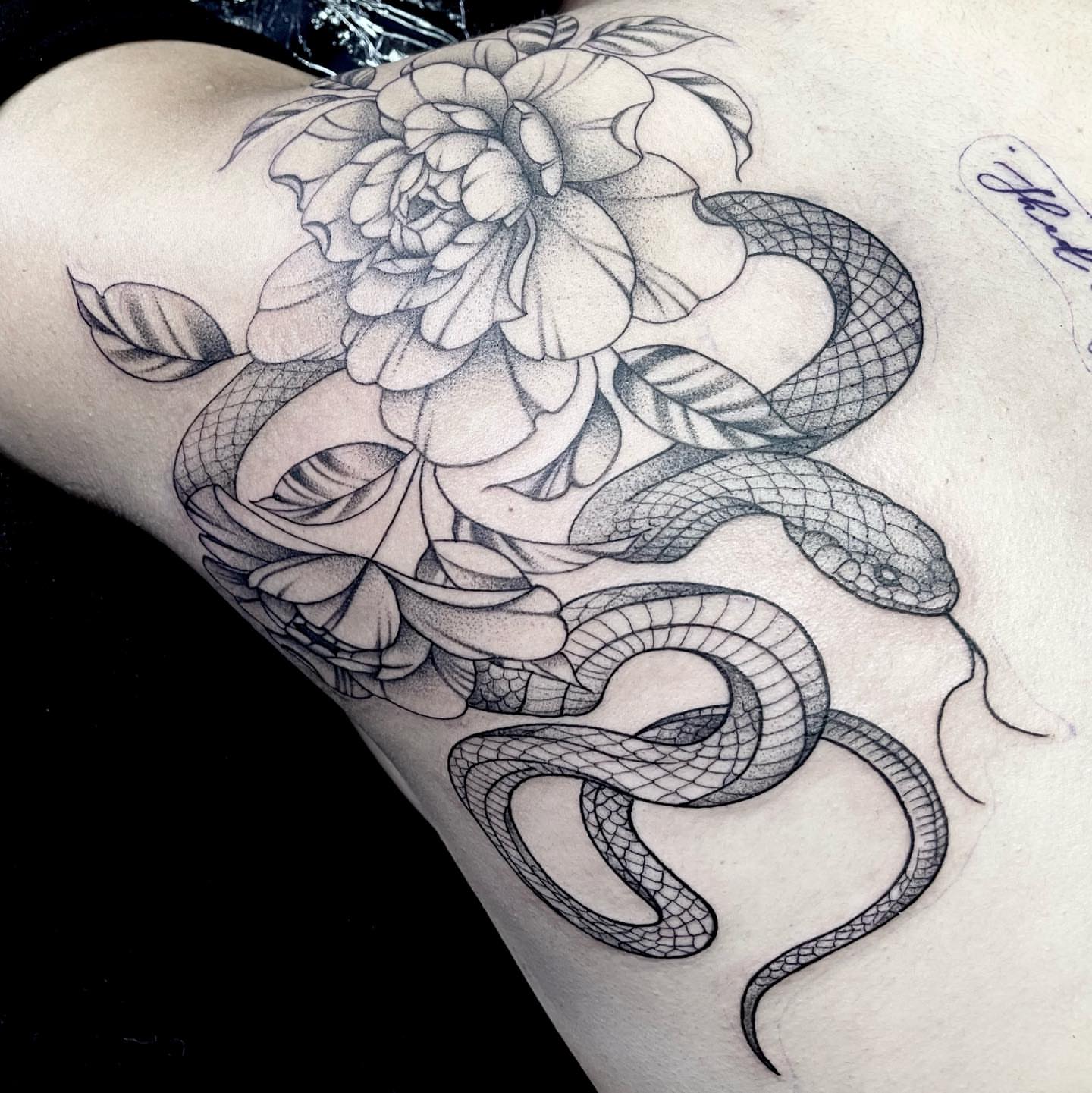 Snake and peony realism tattoo on the thigh by Ducky