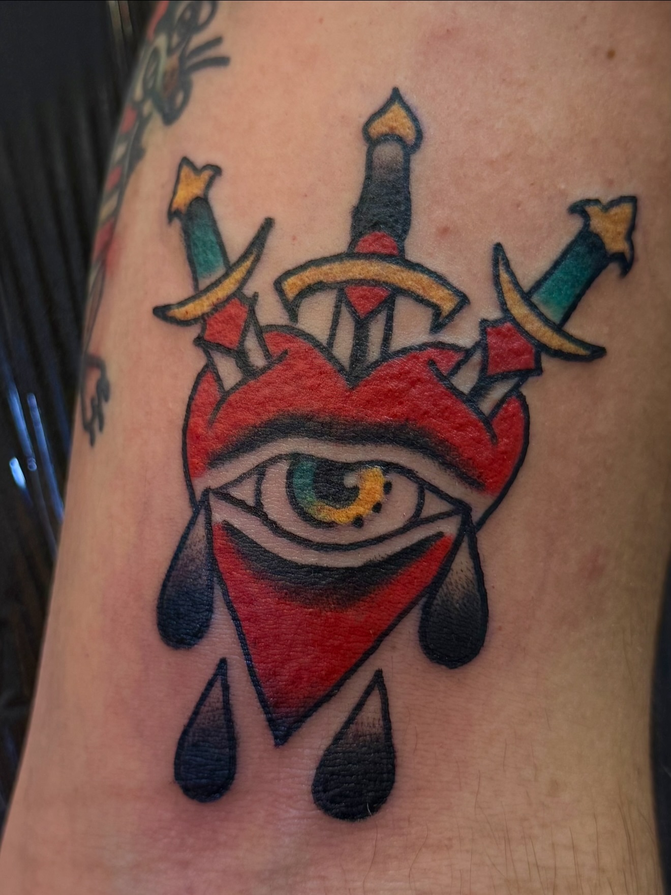 Heart with eye American traditional tattoo on the forearm by Zac Clark