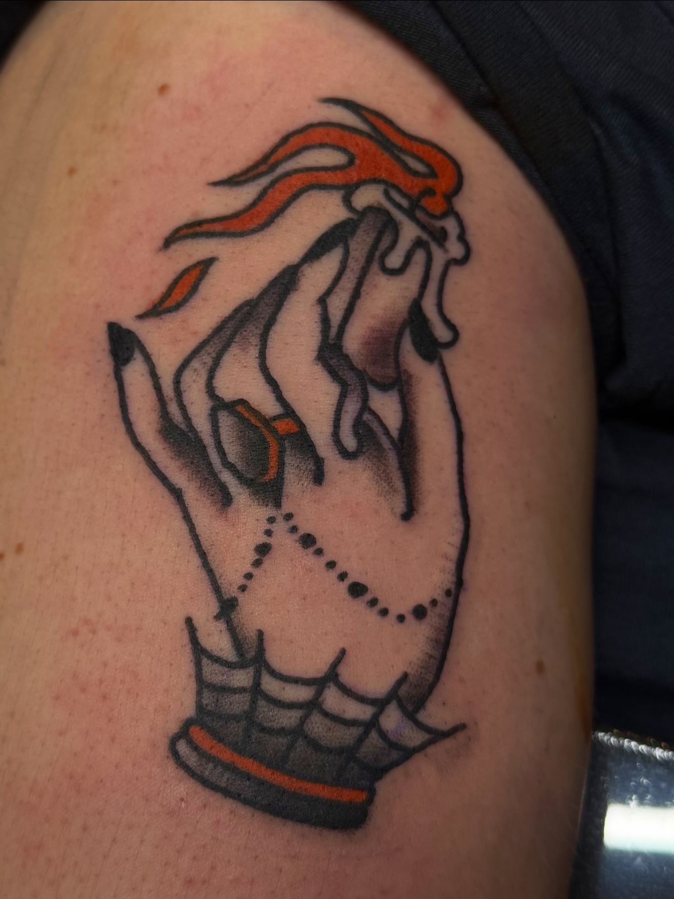 Praying hands American traditional tattoo on the shoulder by Zac Clark