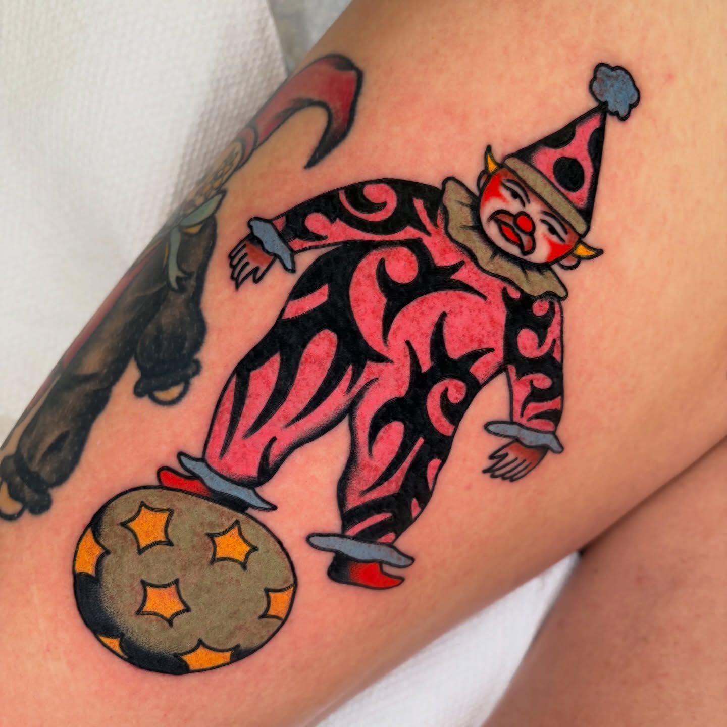 Clown juggling American traditional tattoo on the thigh by rachael