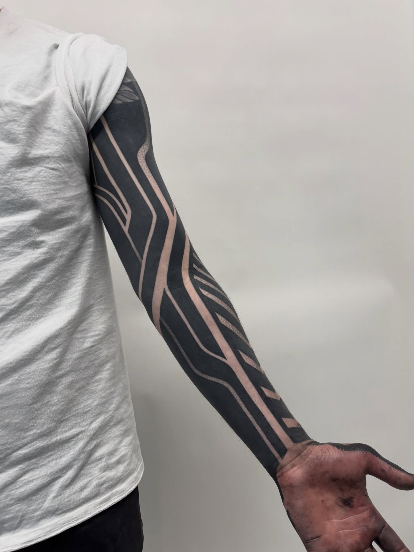 Geometric pattern geometric tattoo on the upper arm by Mitch Koch