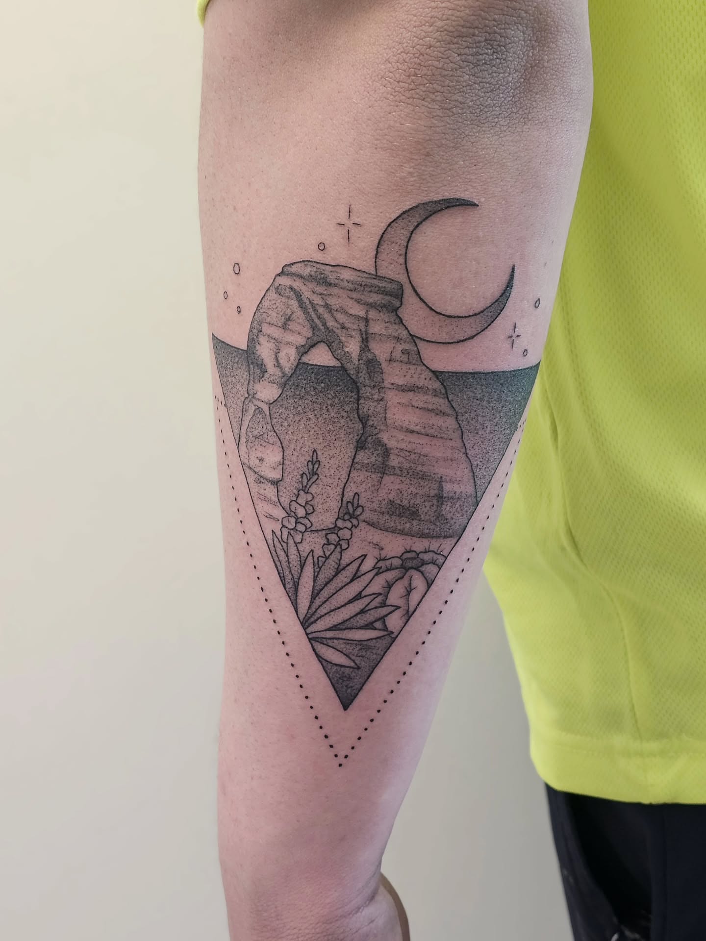 Landscape with arch and crescent moon dotwork tattoo on the forearm by Kylie Lund
