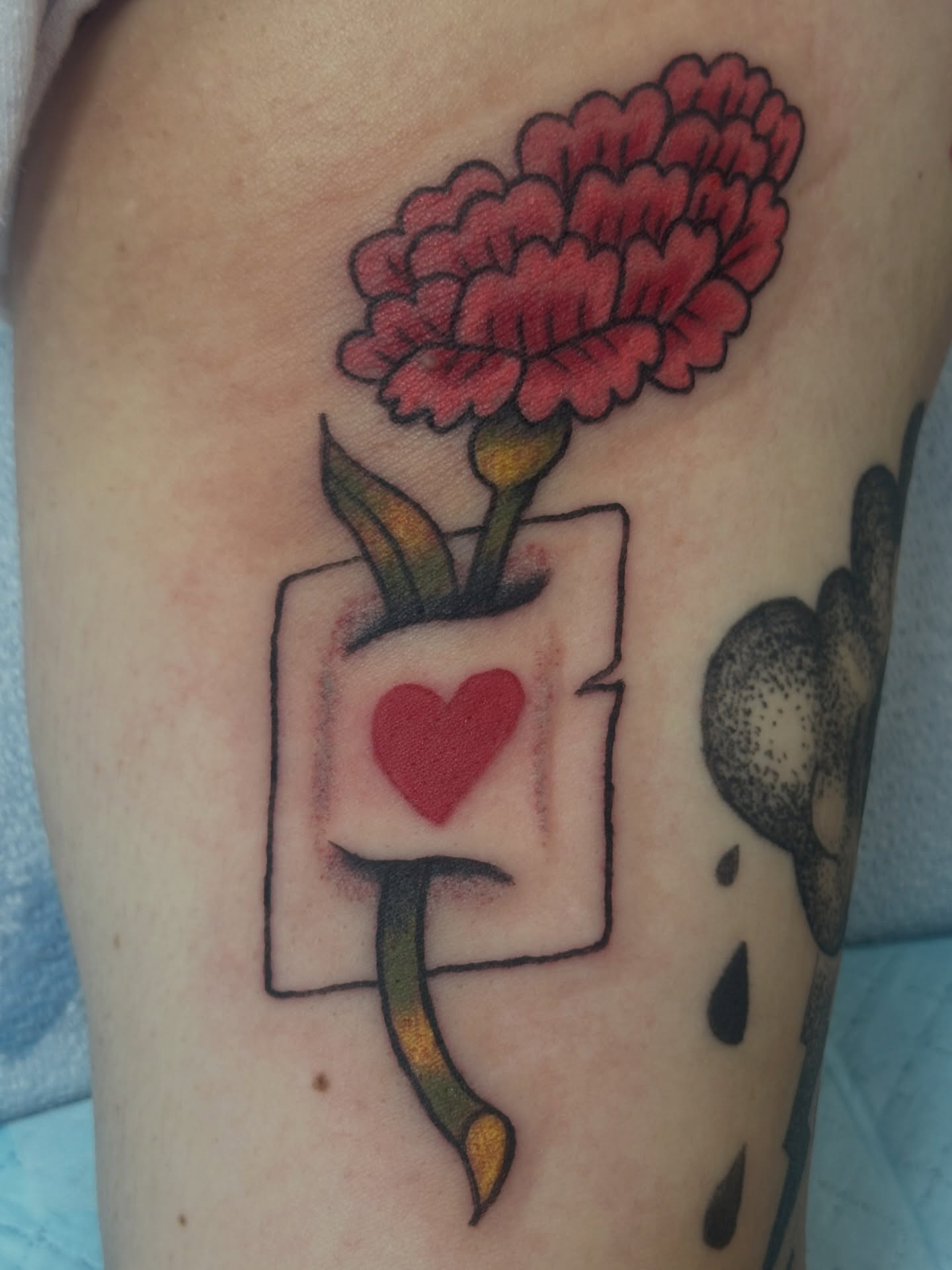 Flower and playing card American traditional tattoo on the thigh by julian solis, Houston, Texas