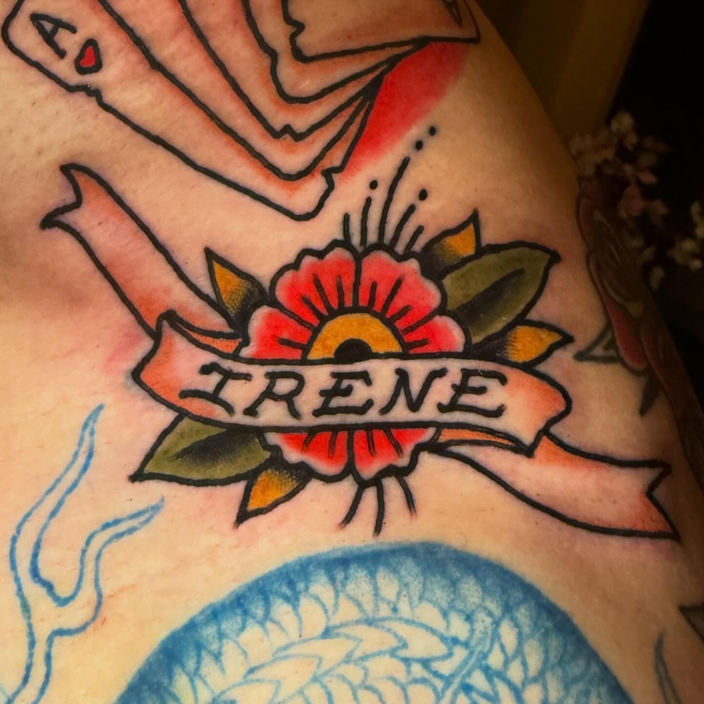 Flower and ribbon American traditional tattoo on the shoulder by Henry Bubula, Minneapolis, Minnesota