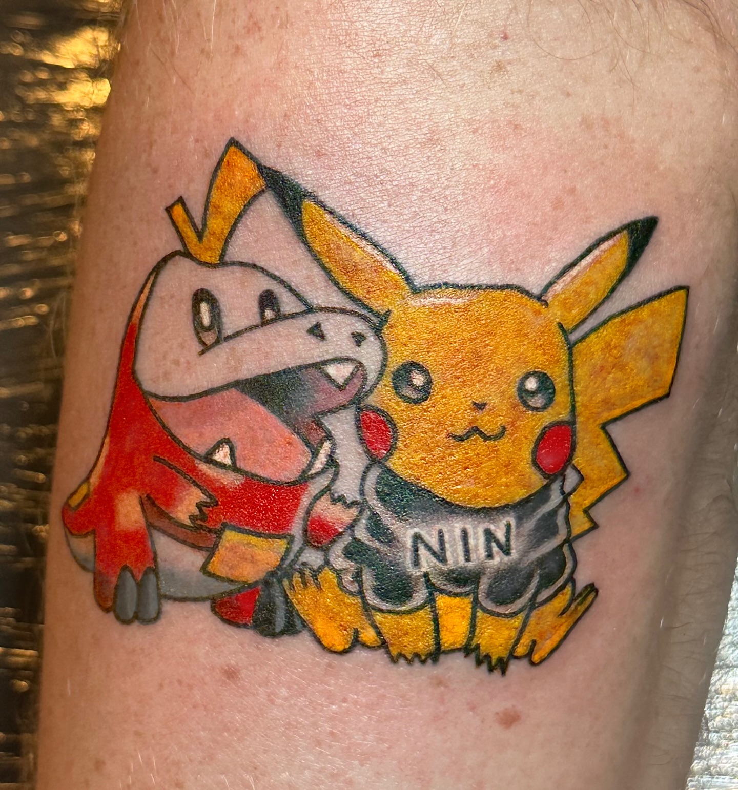 Pikachu and King Dedede American traditional tattoo on the forearm by Hayley Hendrick
