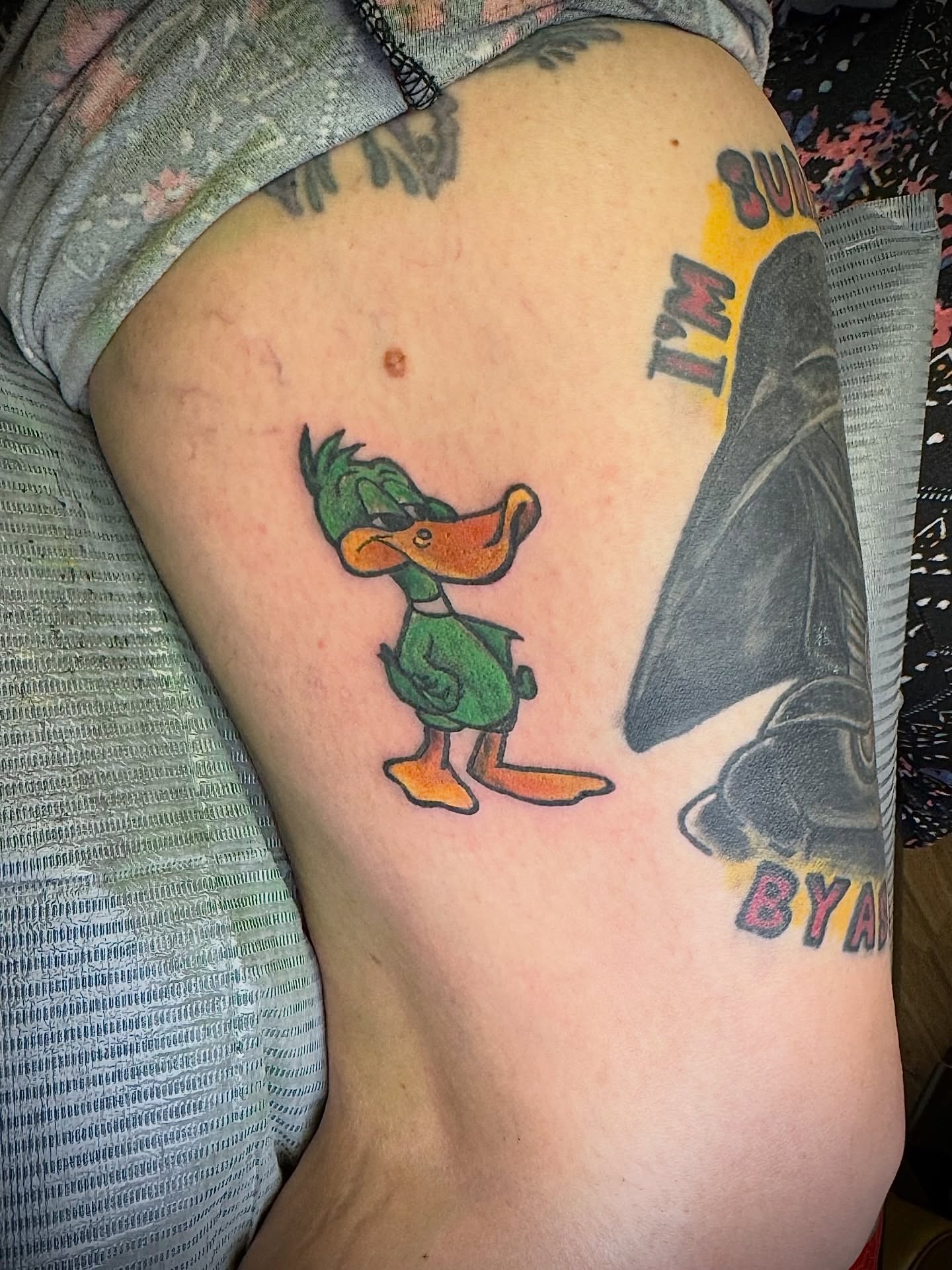 Daffy duck American traditional tattoo on the thigh by Bob Howdy
