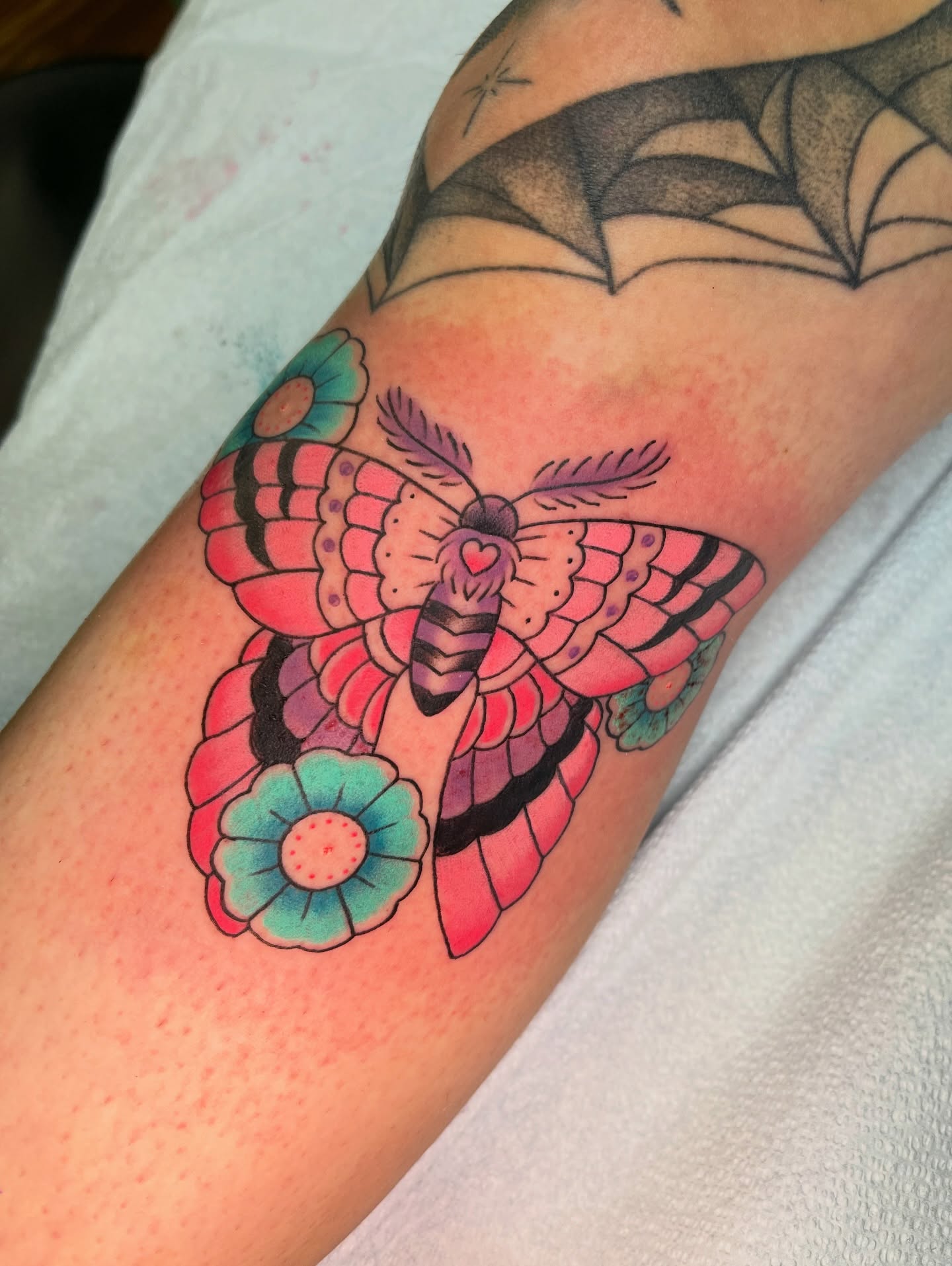 Butterfly and flower American traditional tattoo on the forearm by Blake Alan Tattoos (TROUT)