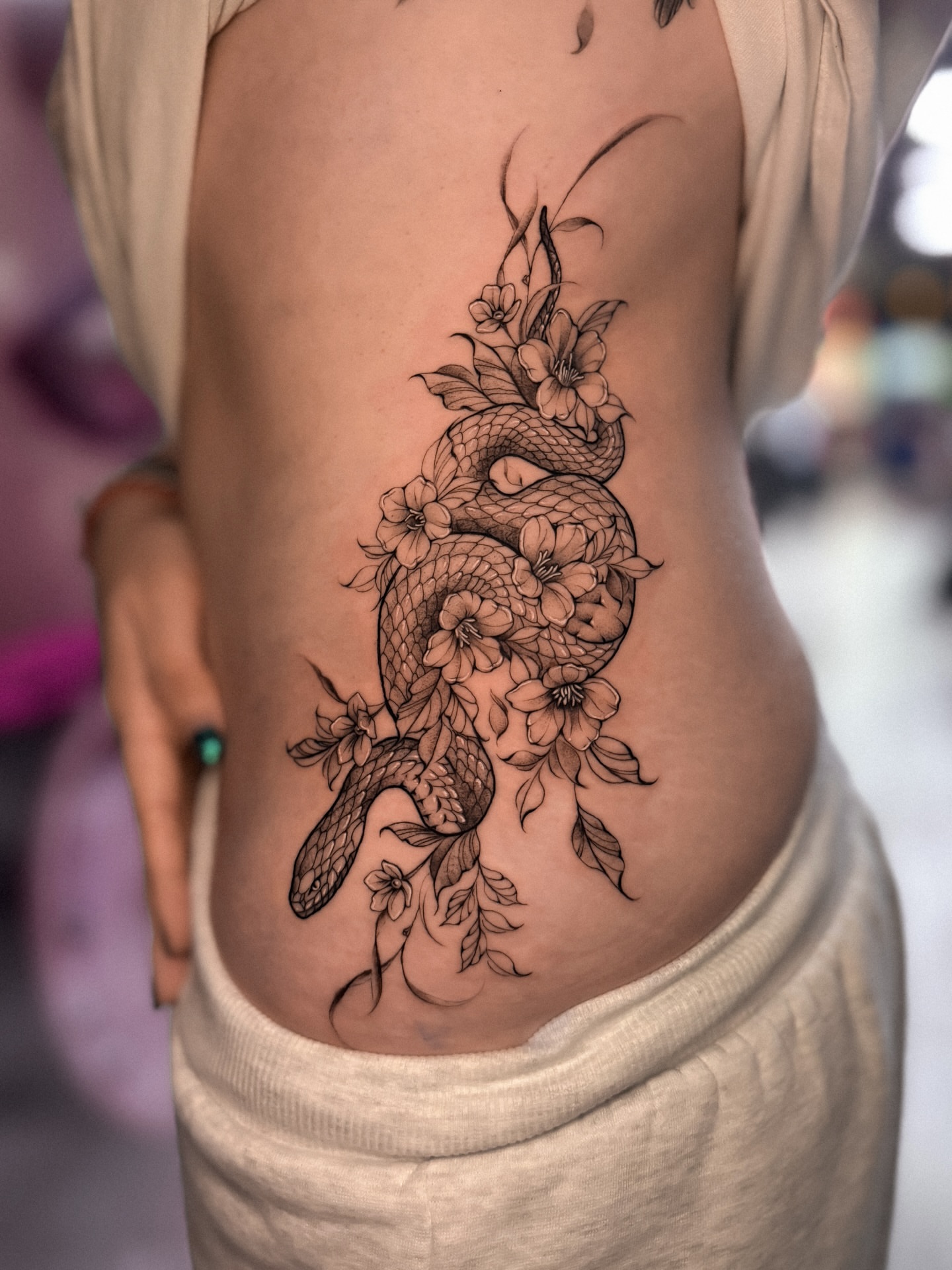 Snake and flowers realism tattoo on the ribs by πππΉππππππππππππ