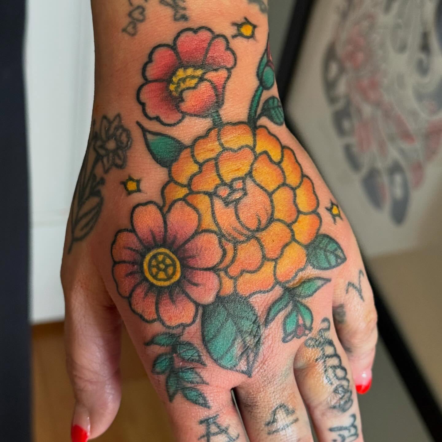 Floral bouquet American traditional tattoo on the hand by Tony Beuke