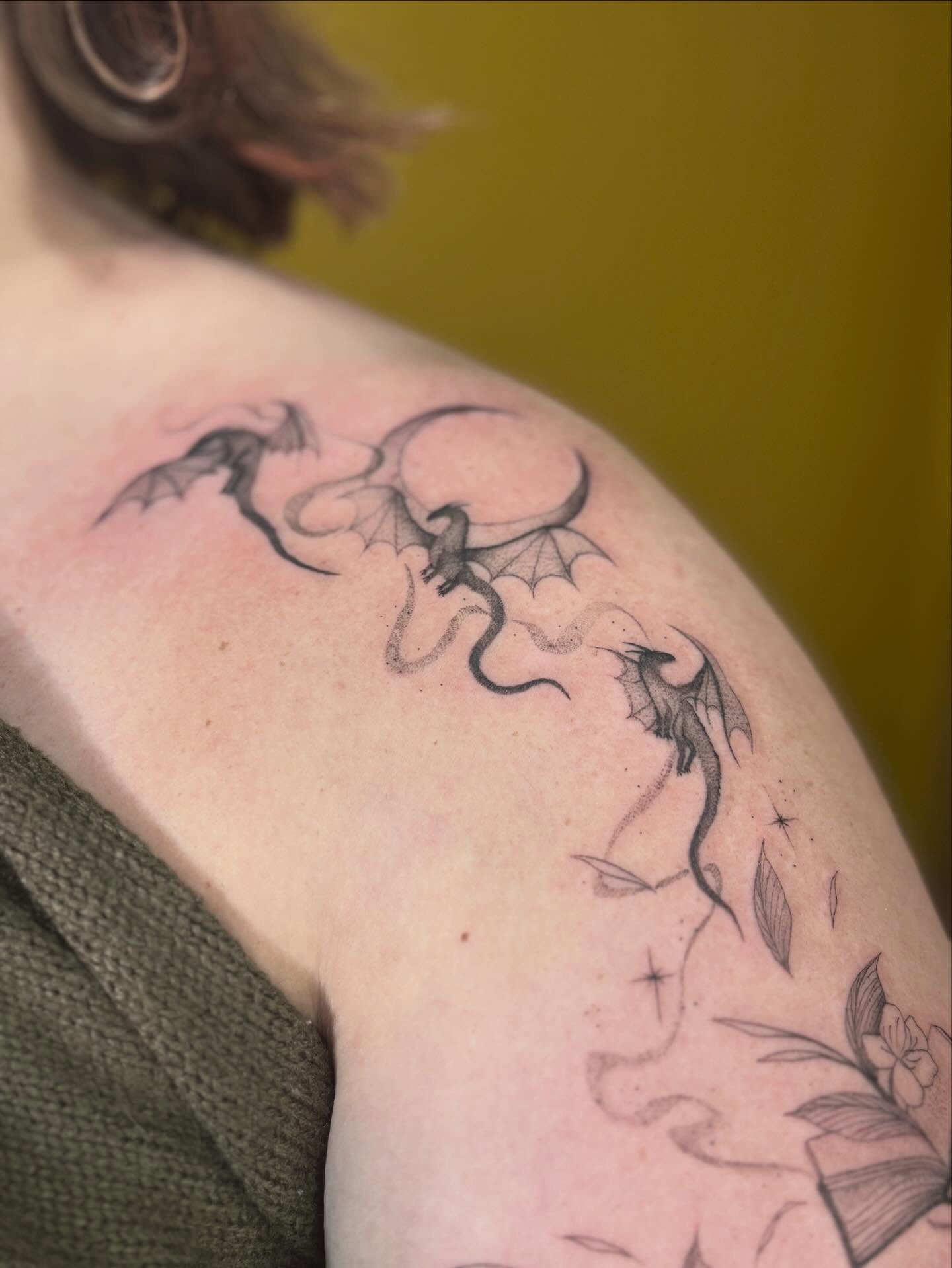 Dragons and flowers black and grey tattoo on the shoulder by Jazzlyn Hous
