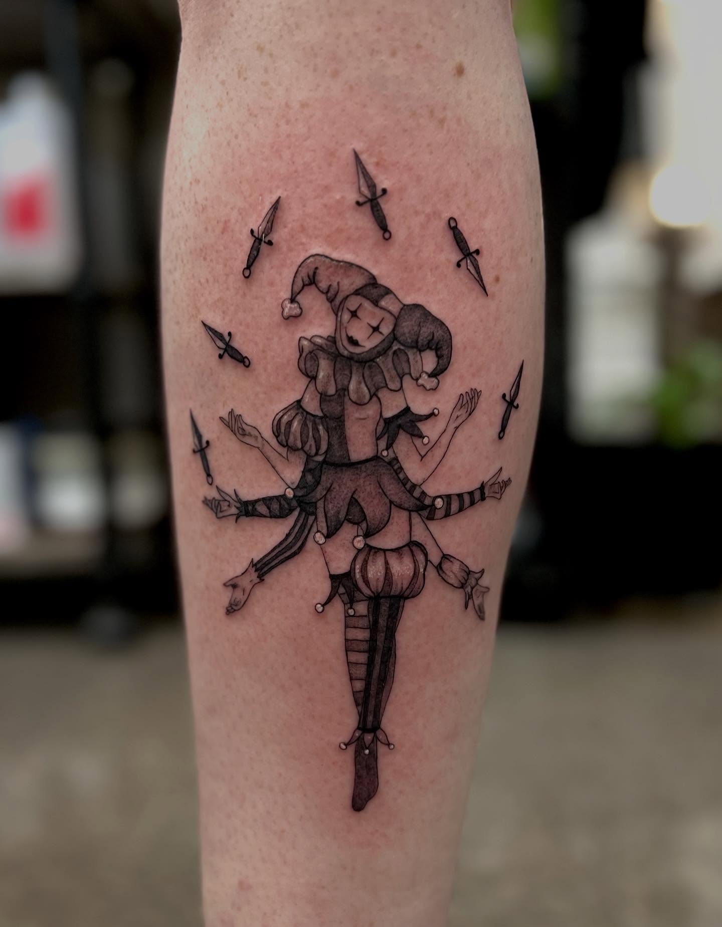 Clown with knives black and grey tattoo on the forearm by 𝖑𝖎𝖑 𝖗𝖎𝖘𝖘
