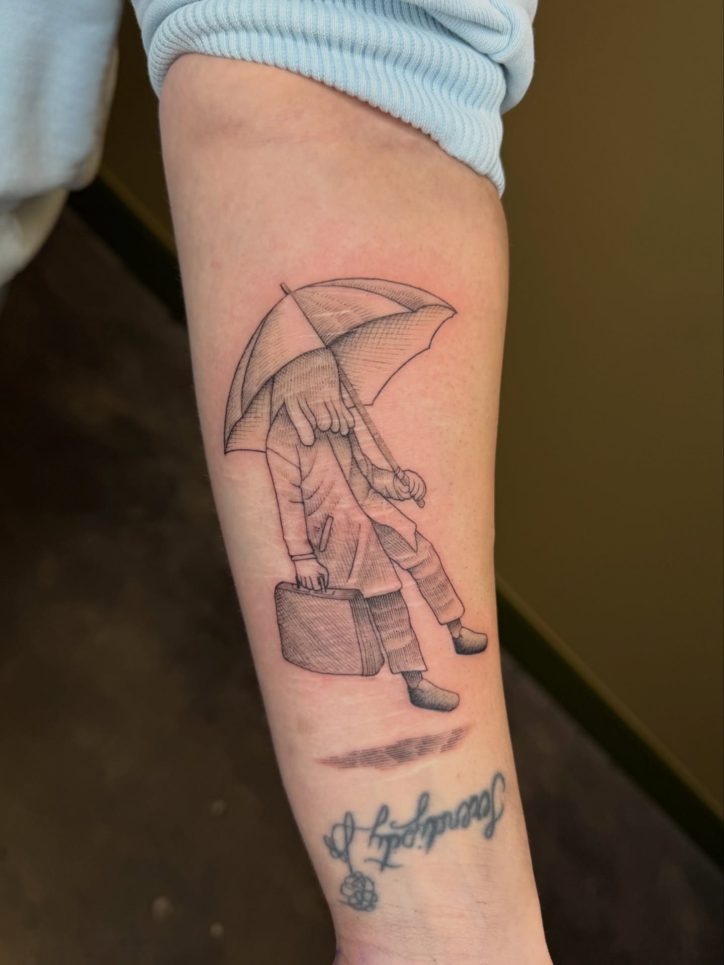 Man with umbrella black and grey tattoo on the forearm by Fabian💉 Tattoo artist