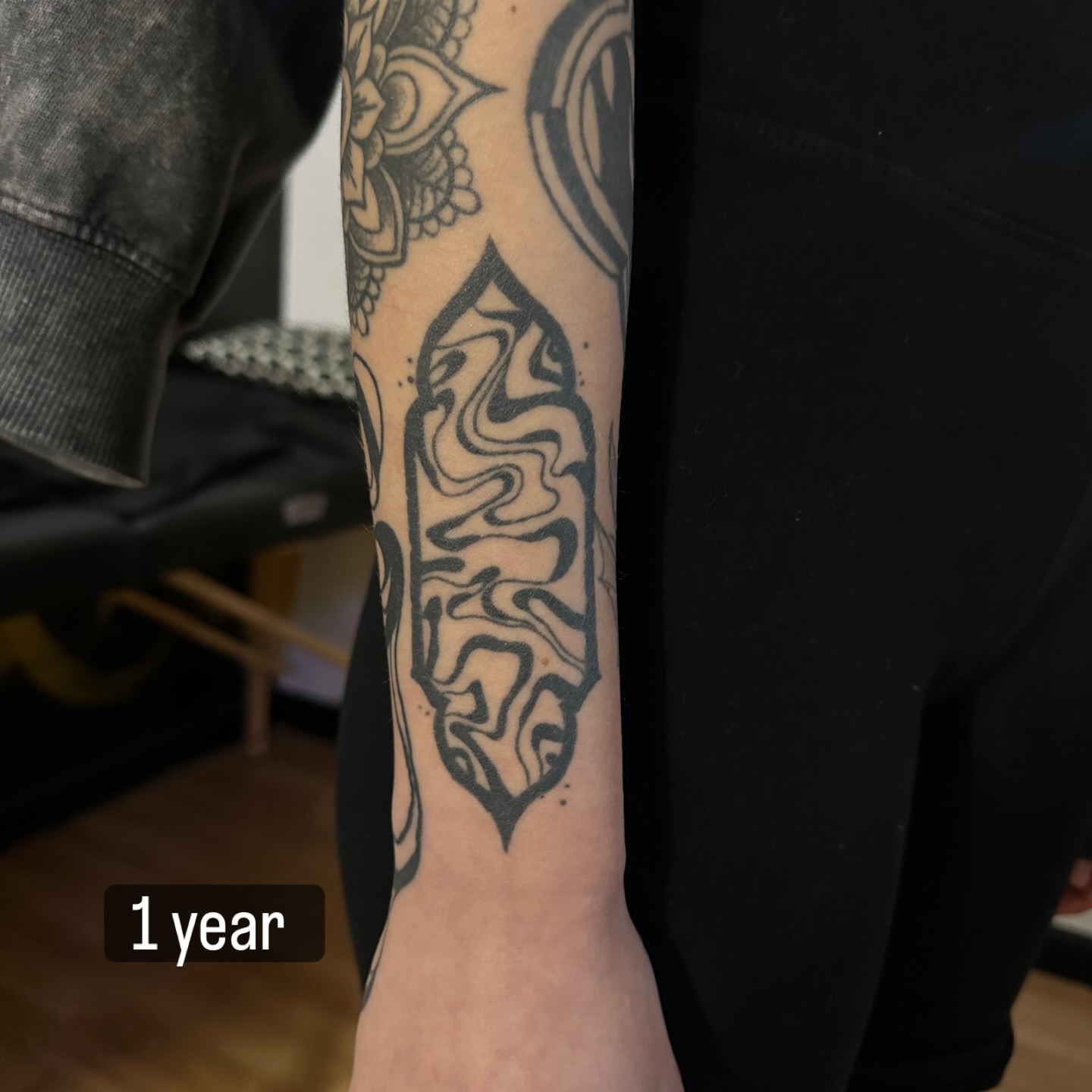 Abstract flame black and grey tattoo on the forearm by Yassin alsaje