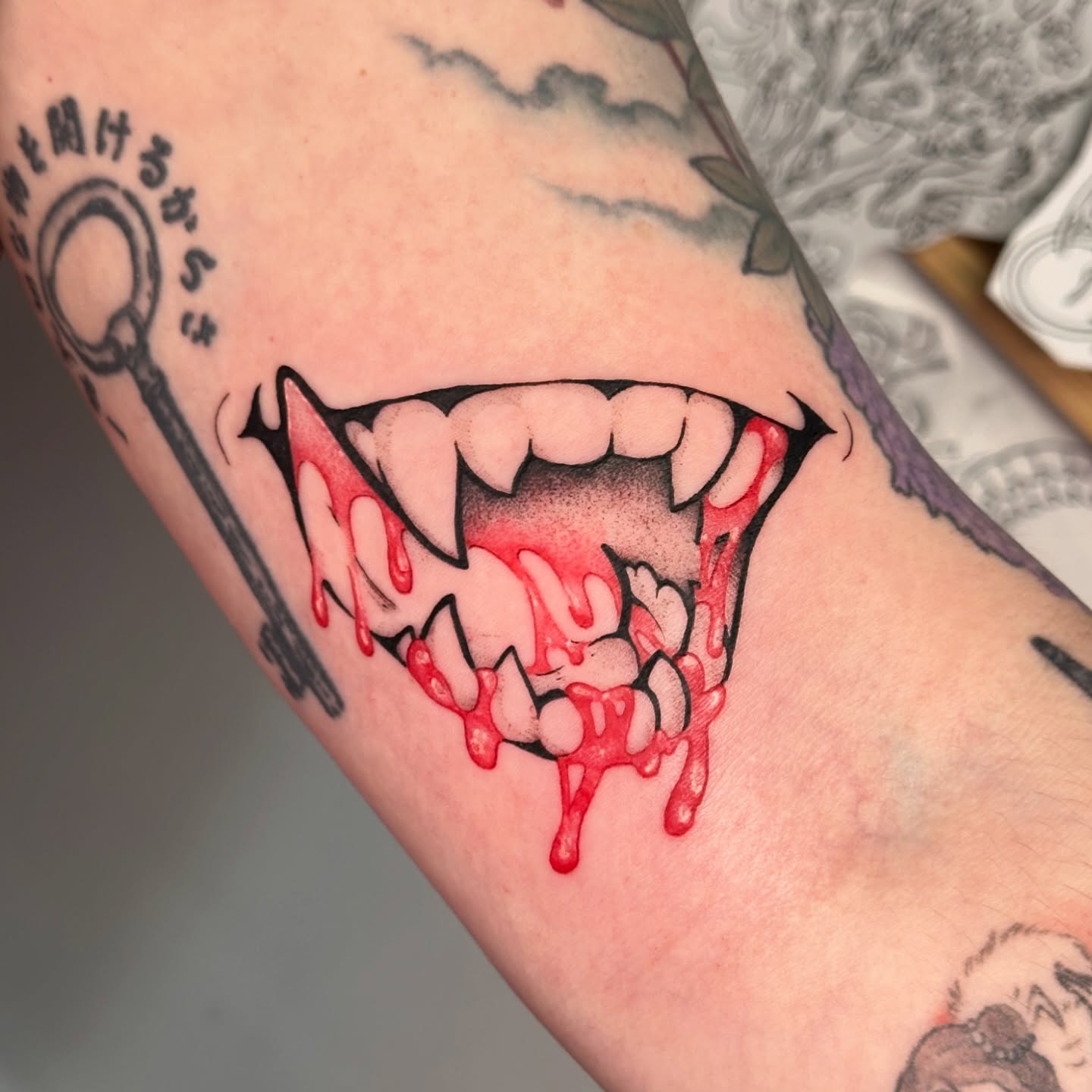 Fangs and blood dark realism tattoo on the forearm by TATTOOLIZARD (James)