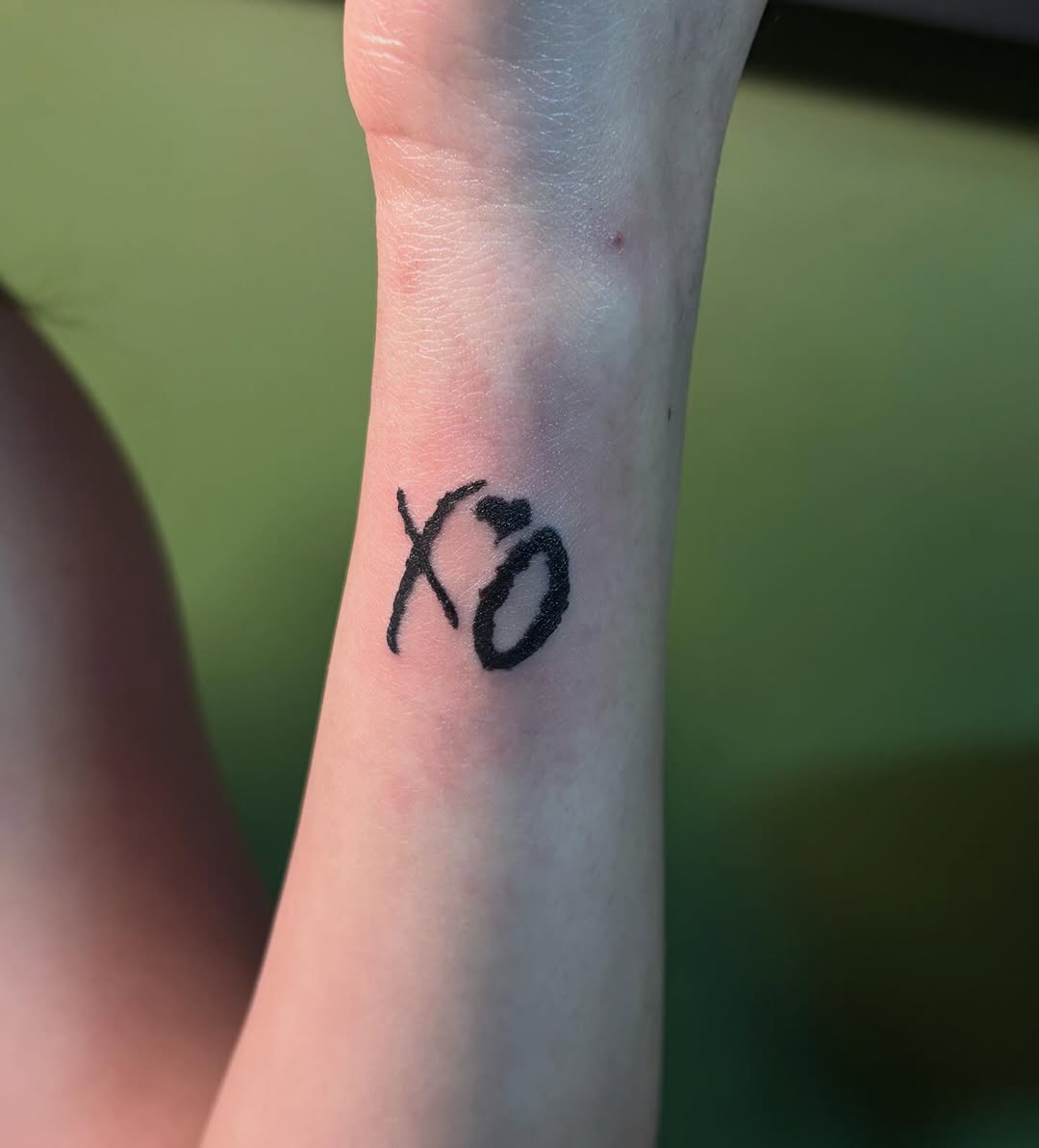 XO logo cyber sigilism tattoo on the forearm by Angel Arceo