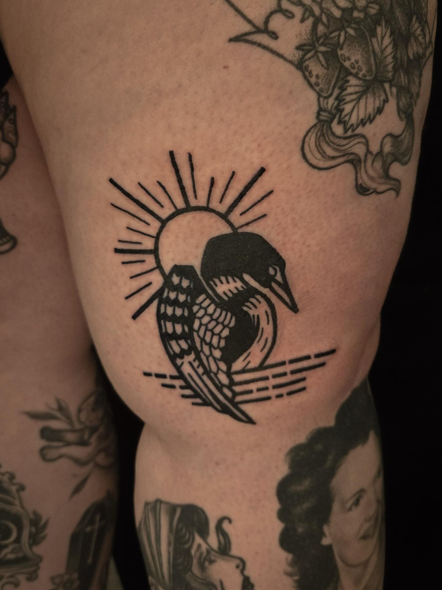 Loon and sun American traditional tattoo on the thigh by ashley blyght
