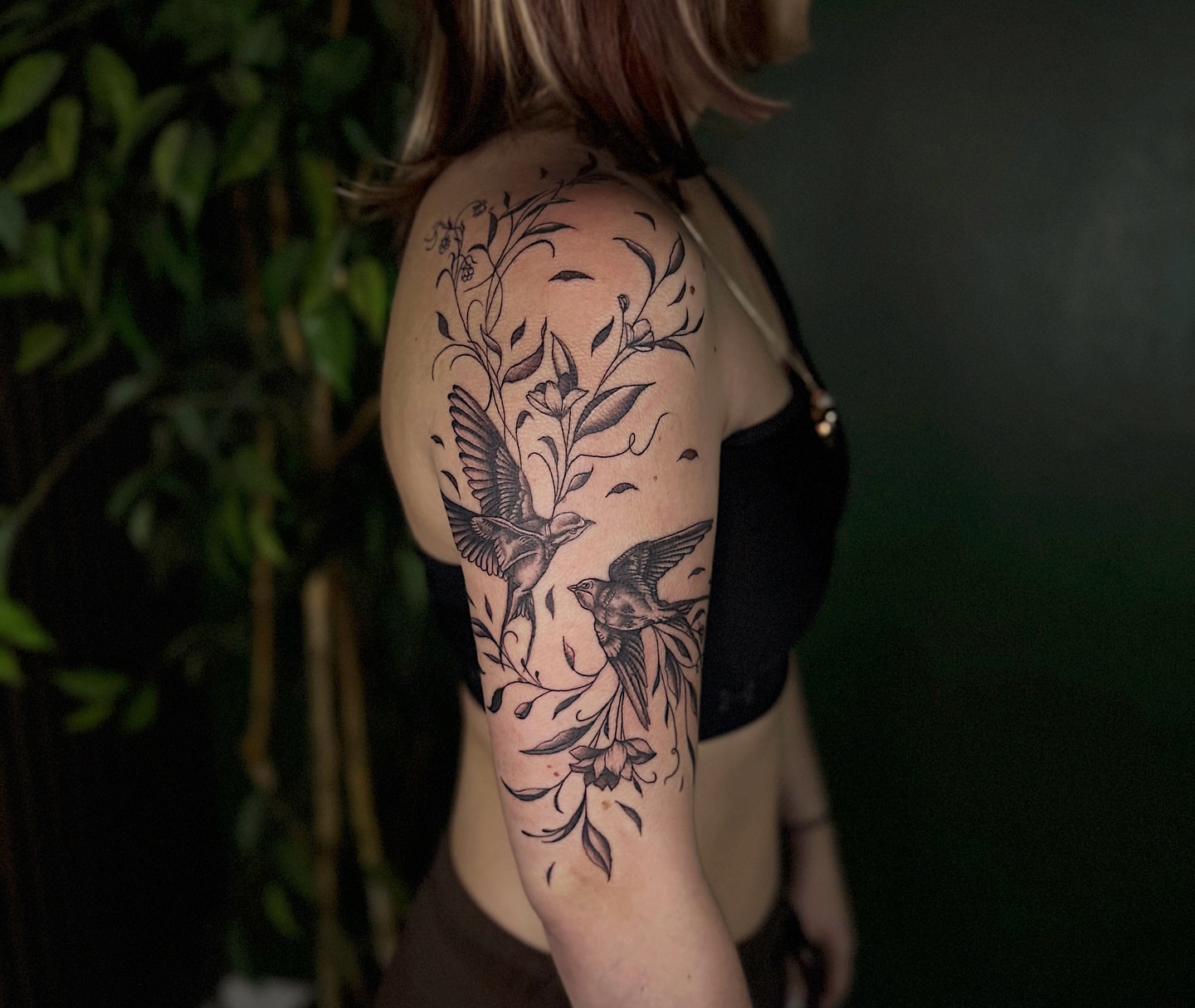 Birds and flowers black and grey tattoo on the shoulder by Breanna Werner