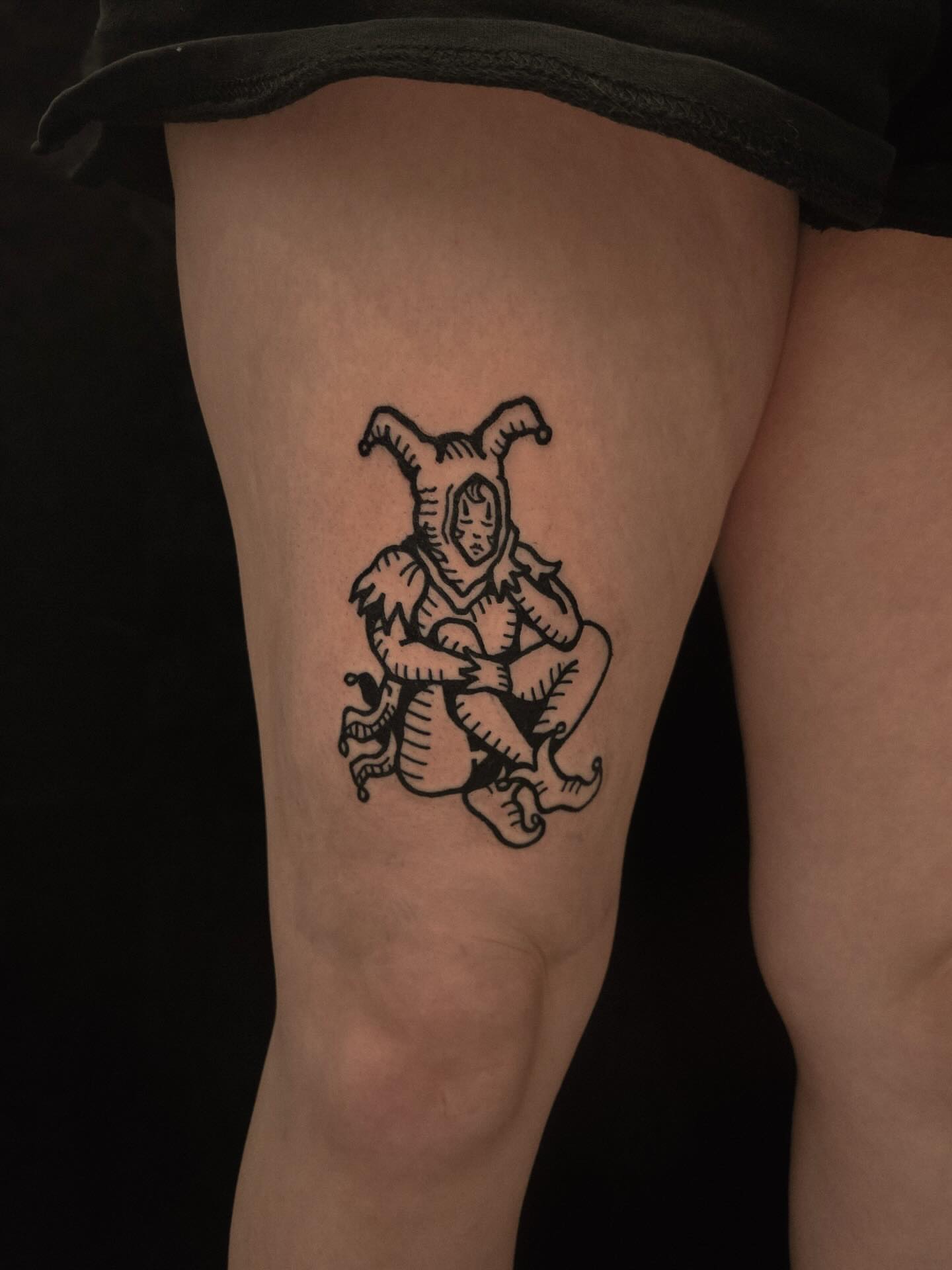 Elf-like creature black and grey tattoo on the thigh by ashley blyght