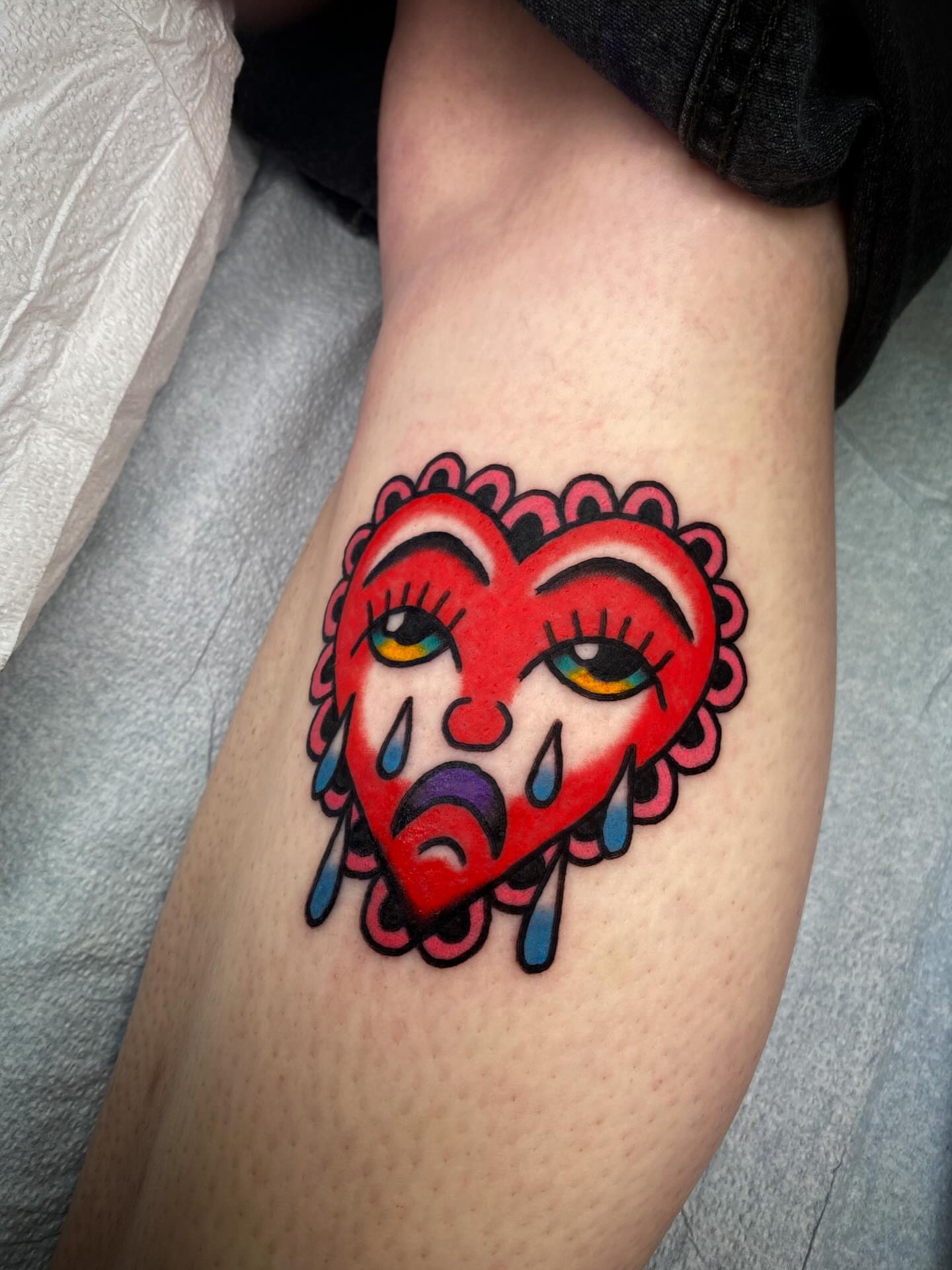 Heart with face American traditional tattoo on the forearm by @rubber_band_dan, San Francisco, California