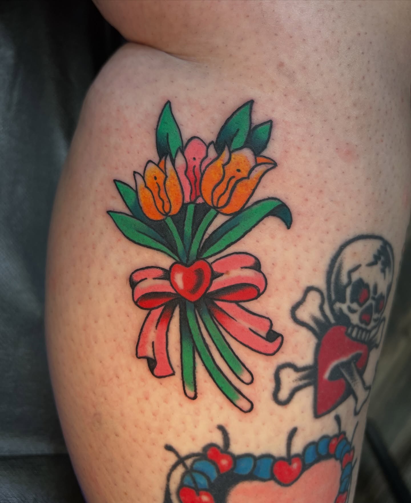 Flowers and bow American traditional tattoo on the thigh by 🍊Harvey Perez 🍊, Deerfield Beach, Florida