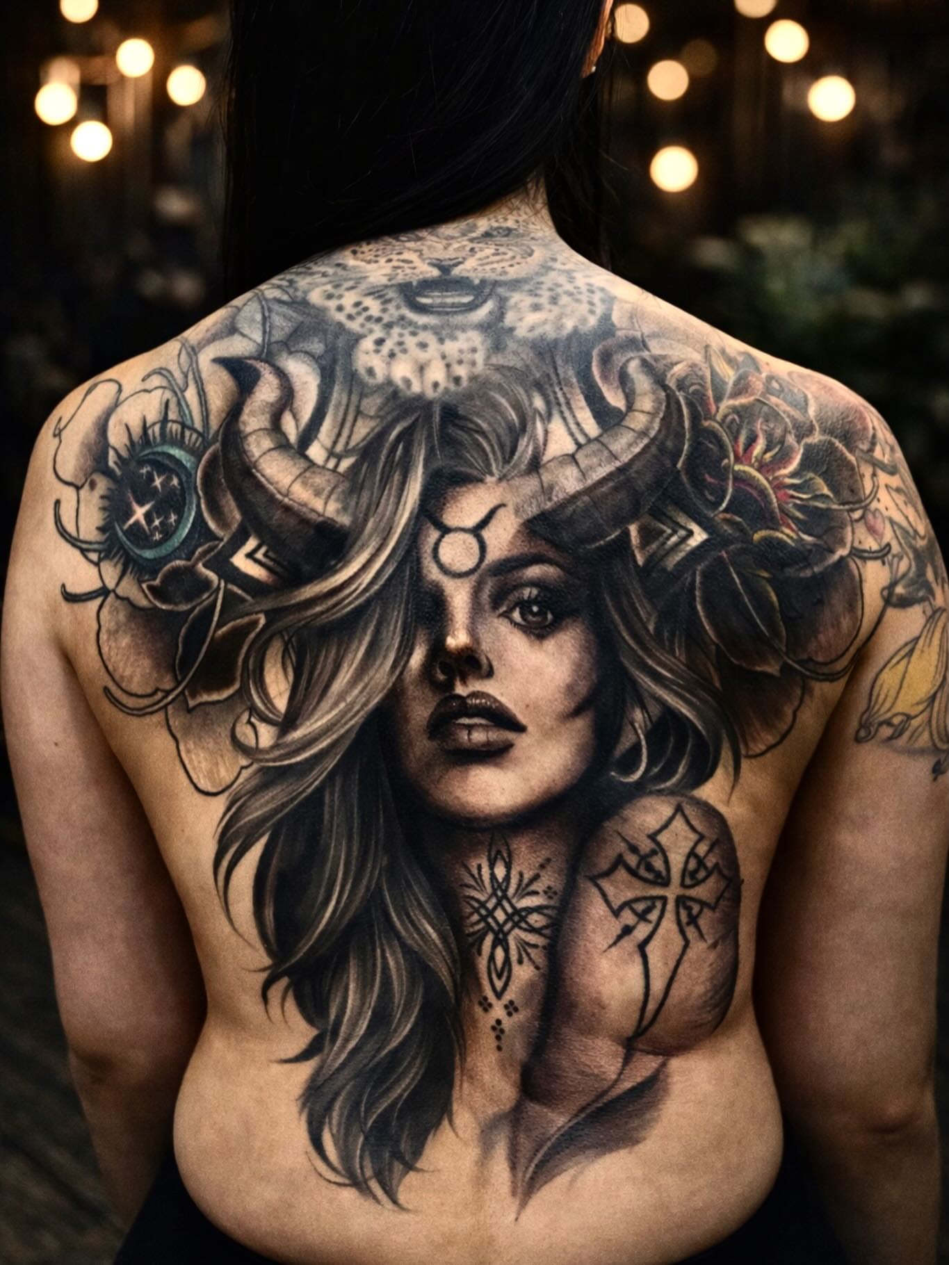 Woman with horns realism tattoo on the back by Angel Jmz