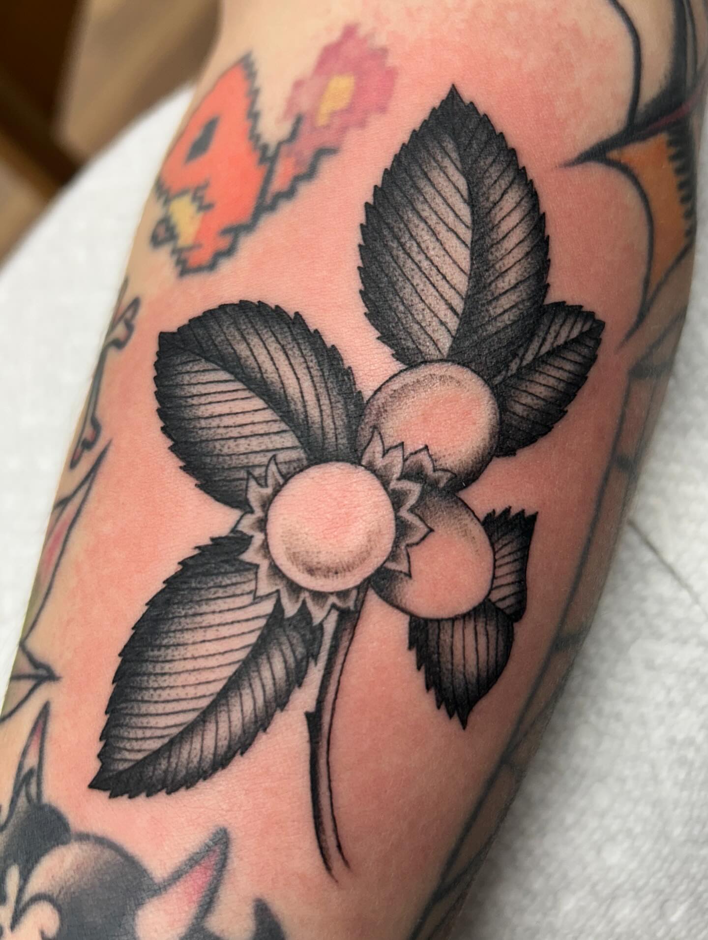 Flower and leaves American traditional tattoo on the forearm by Tiffany Vargas