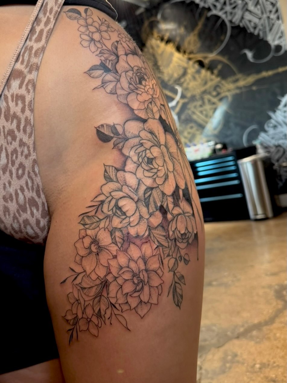 Floral bouquet black and grey tattoo on the shoulder by Gabrielle Mack
