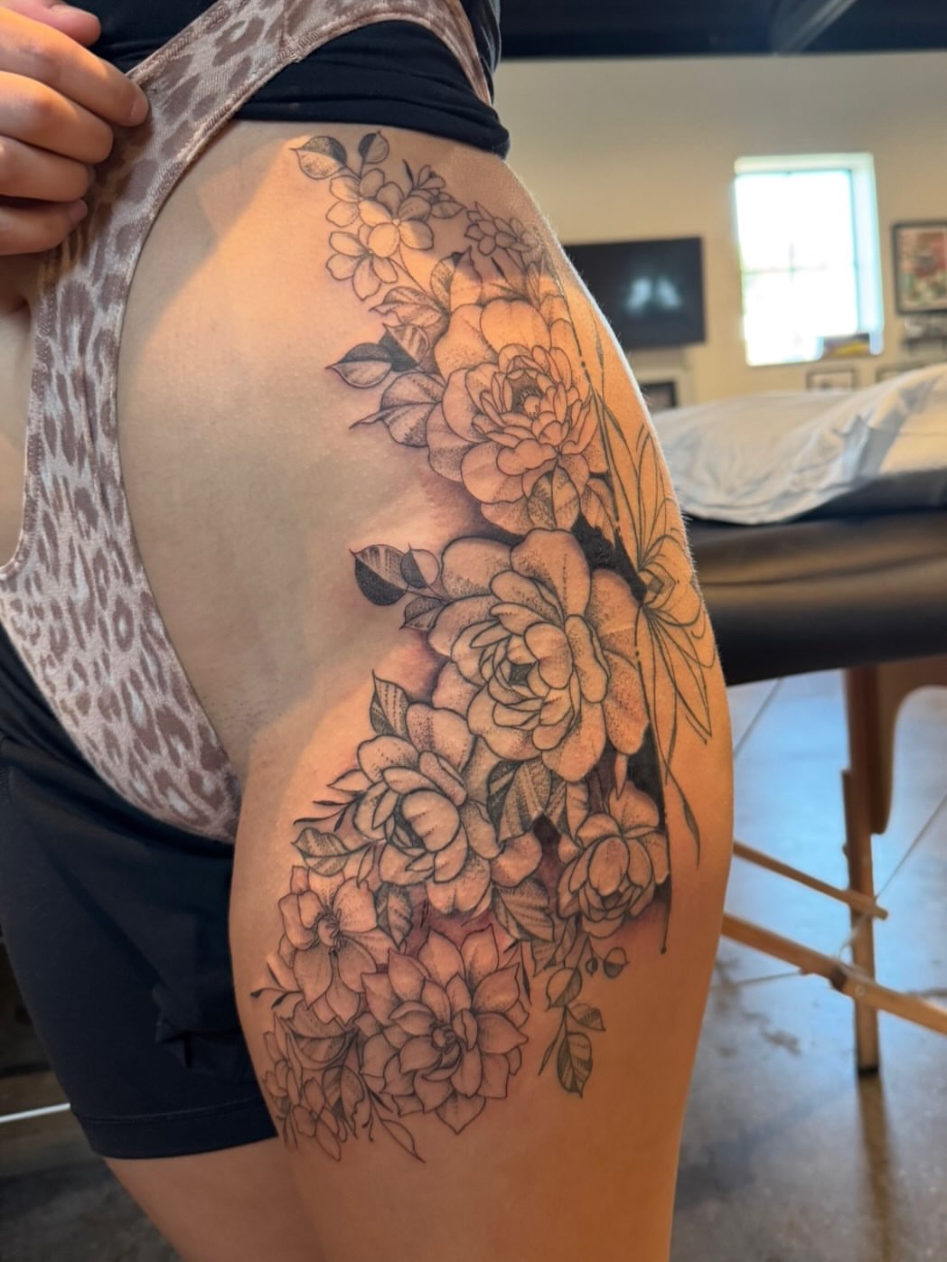 Floral bouquet black and grey tattoo on the thigh by Gabrielle Mack