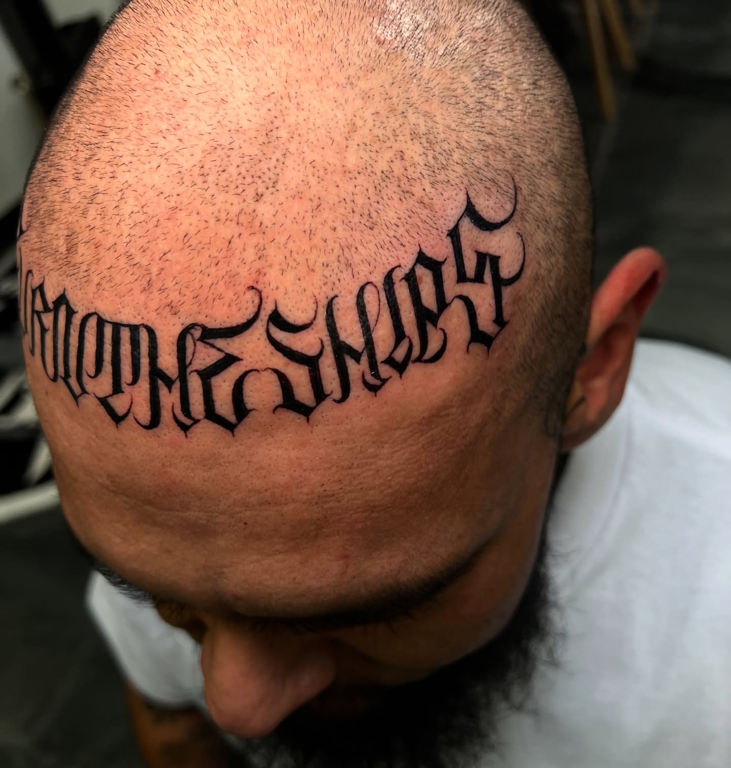 Gothic script lettering script tattoo on the head by Lettering
