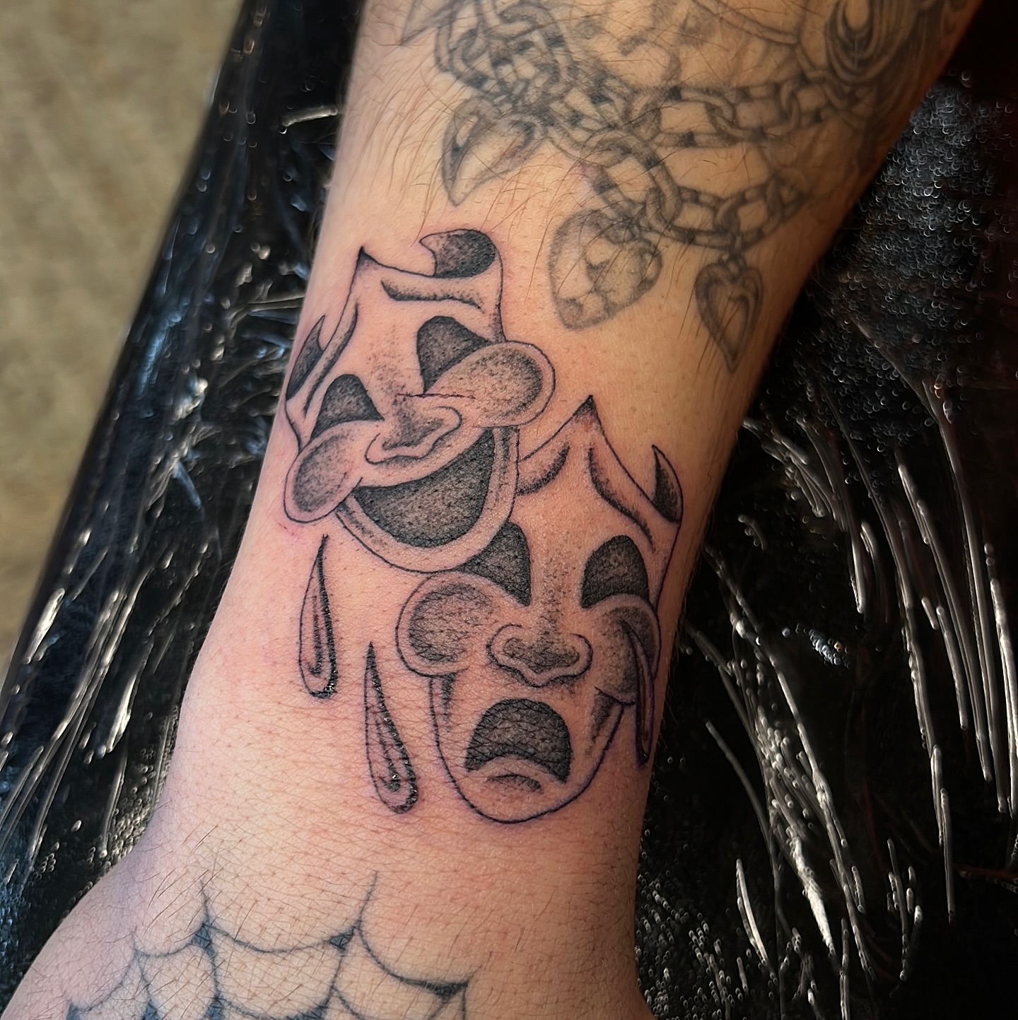 Crying face black and grey tattoo on the forearm by David Delacruz