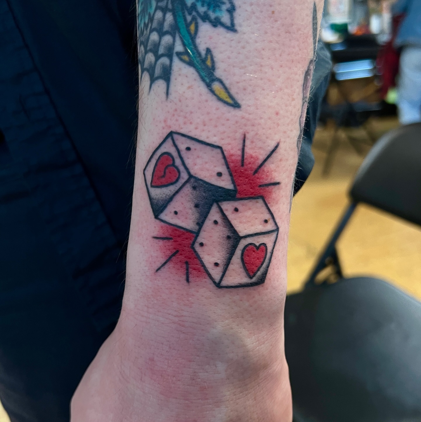 Dice with hearts American traditional tattoo on the forearm by David Delacruz