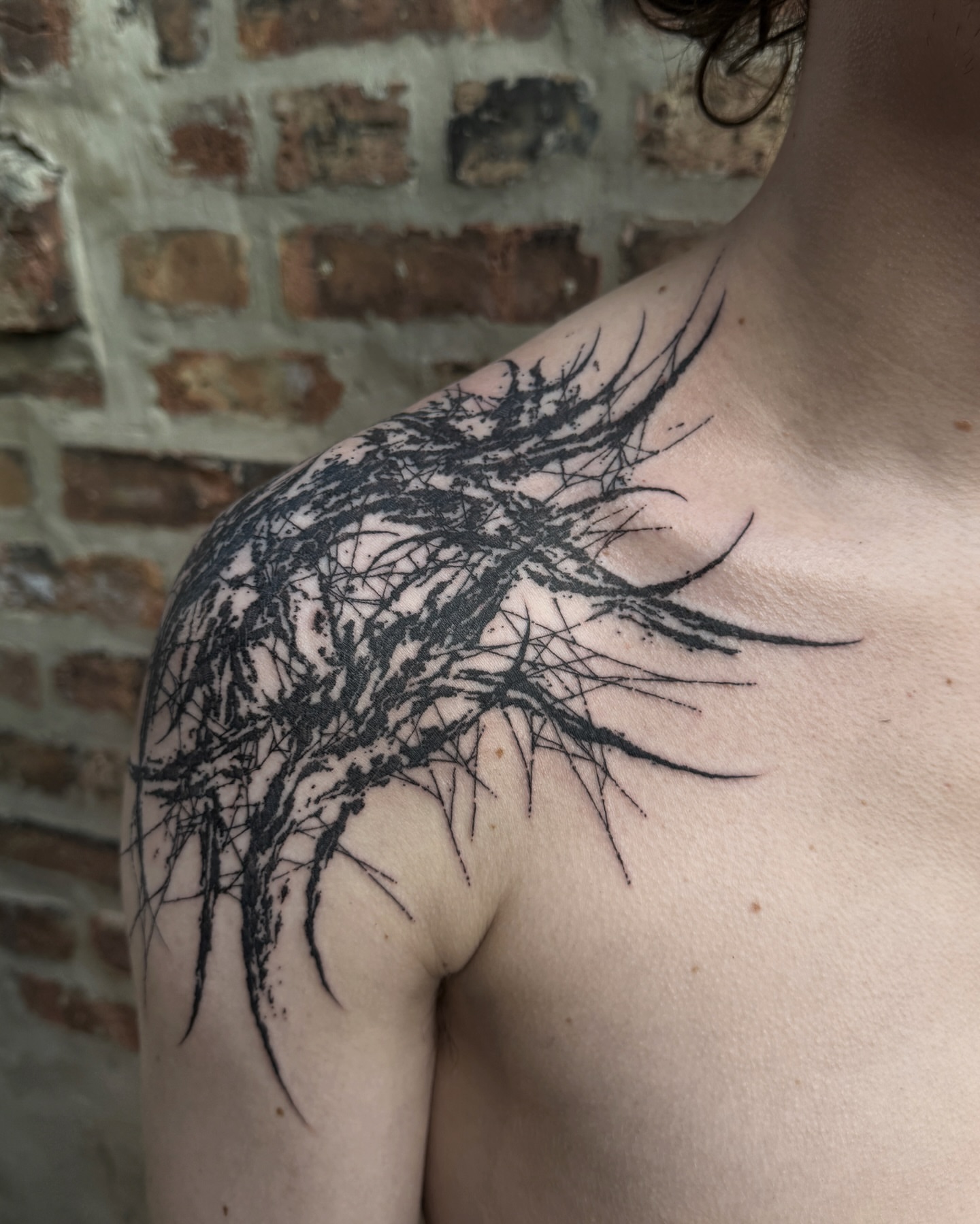 Abstract branches black and grey tattoo on the shoulder by Penelope