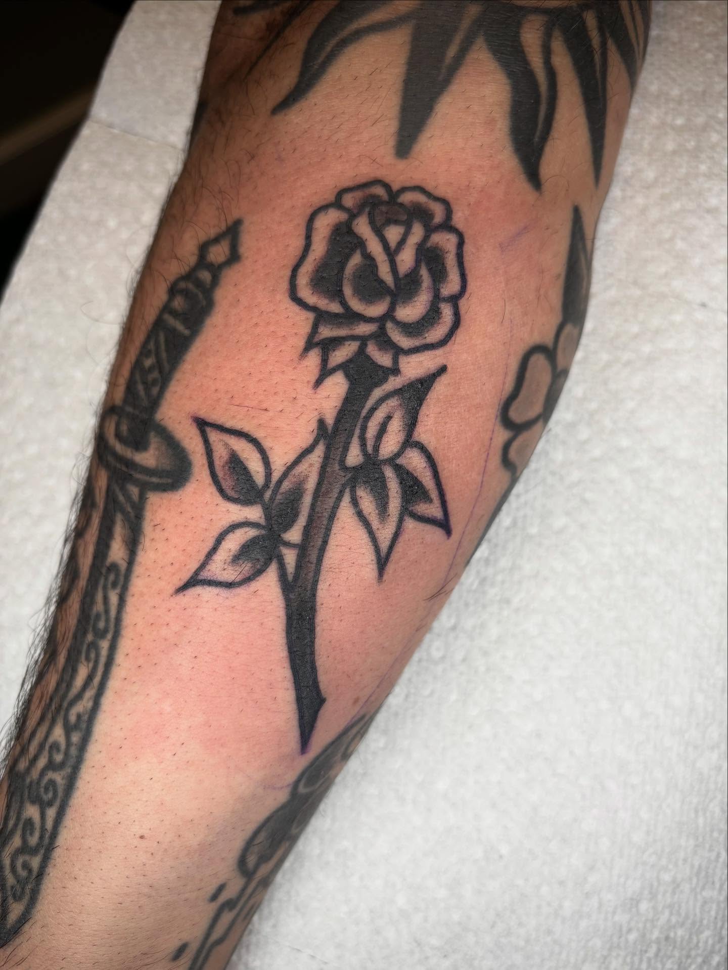 Rose and dagger black and grey tattoo on the forearm by 🌹