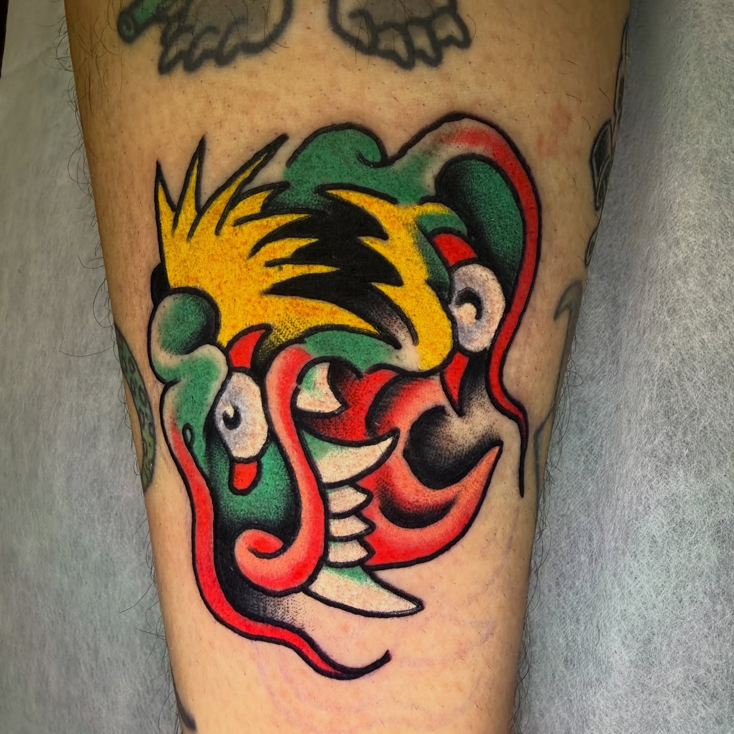 Jester American traditional tattoo on the forearm by Mike Dunn