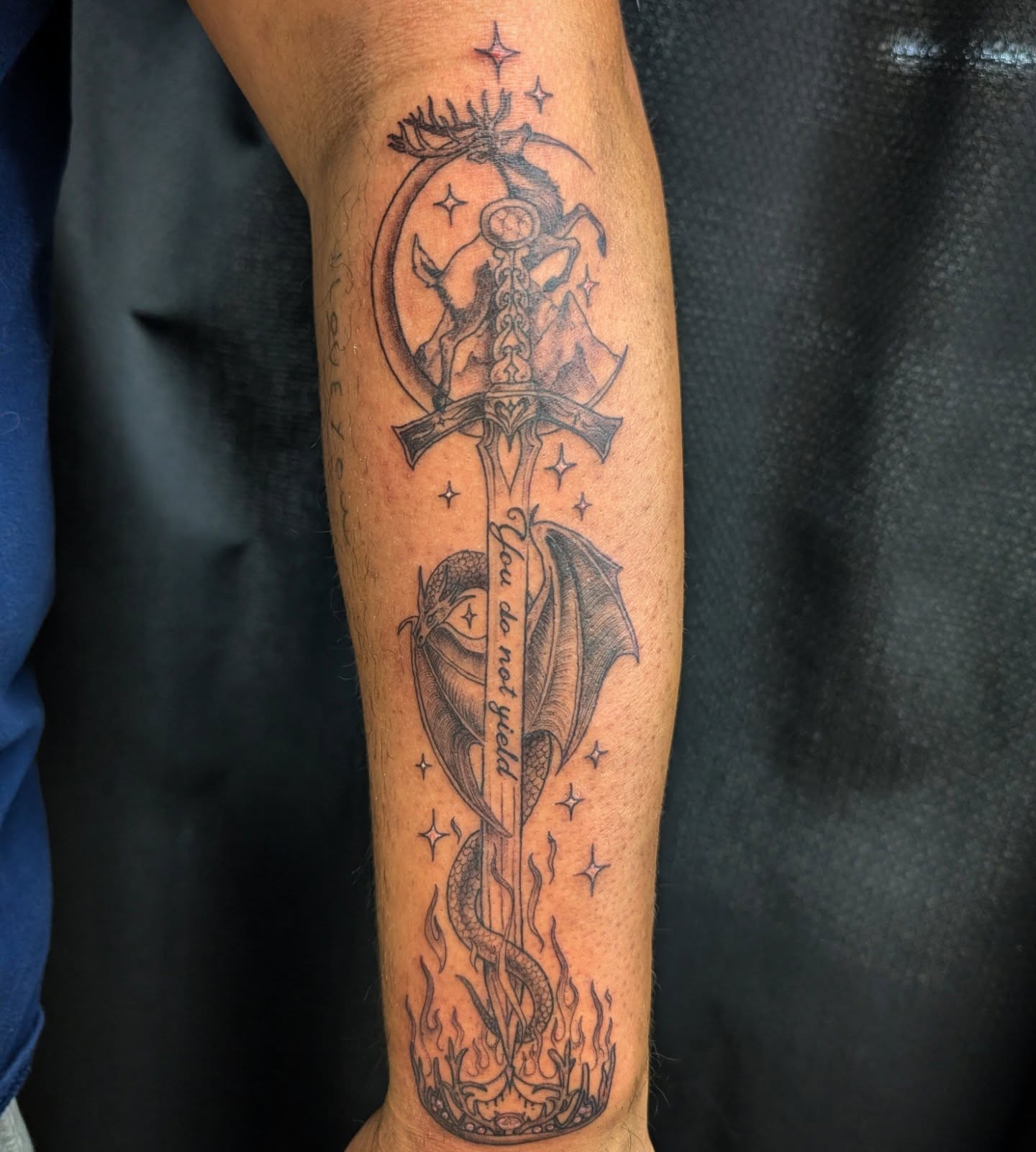 Sword and dragon geometric tattoo on the forearm by Katherine