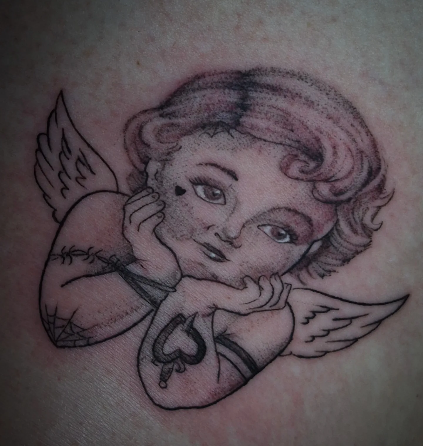 Cherub dotwork tattoo on the torso by Lydia Kiley