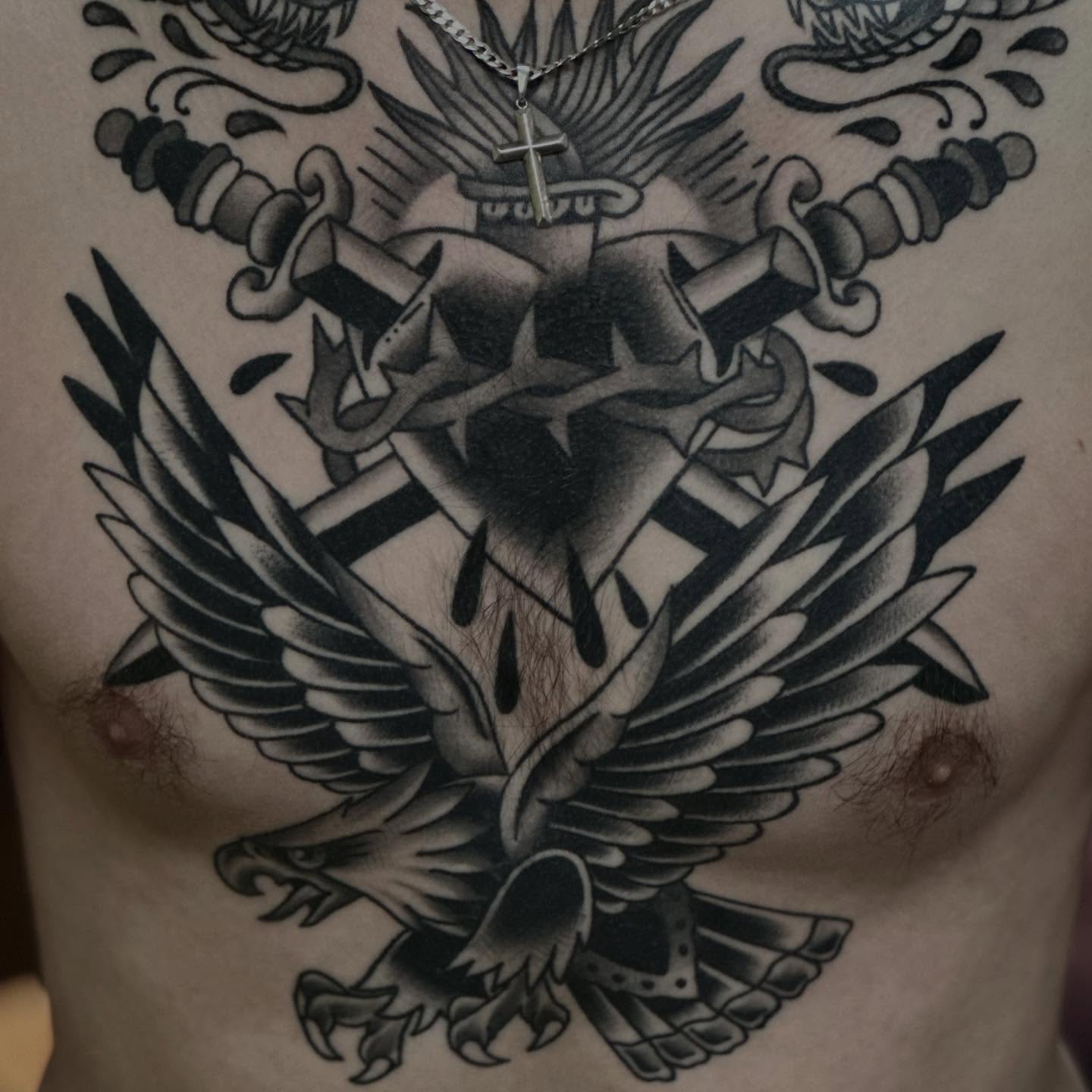 Eagle with cross and swords American traditional tattoo on the chest by Dylan Curry