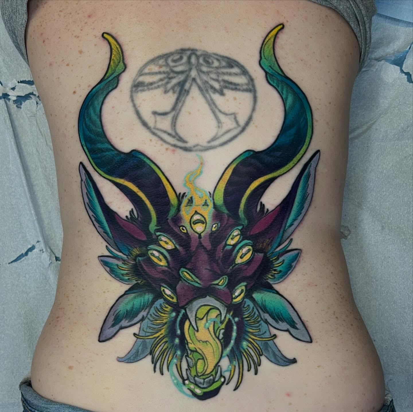 Demon head dotwork tattoo on the ribs by Kate Erso