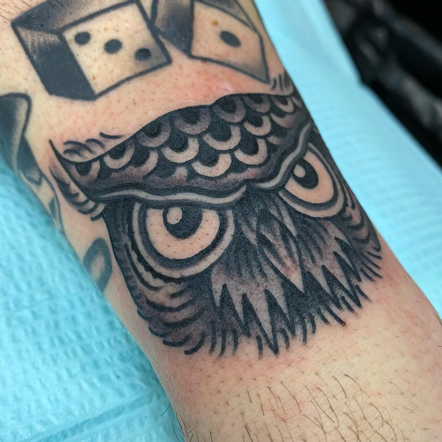 Owl American traditional tattoo on the forearm by Tom Wenzell