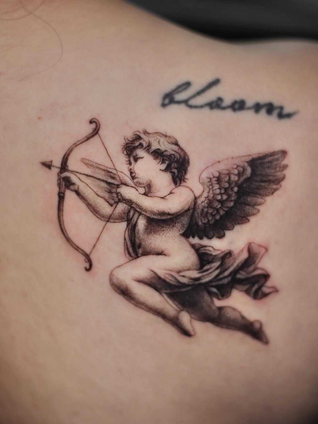 Cherub with bow and arrow ignorant tattoo by 𝐒𝐡𝐞𝐫𝐥𝐥𝐲